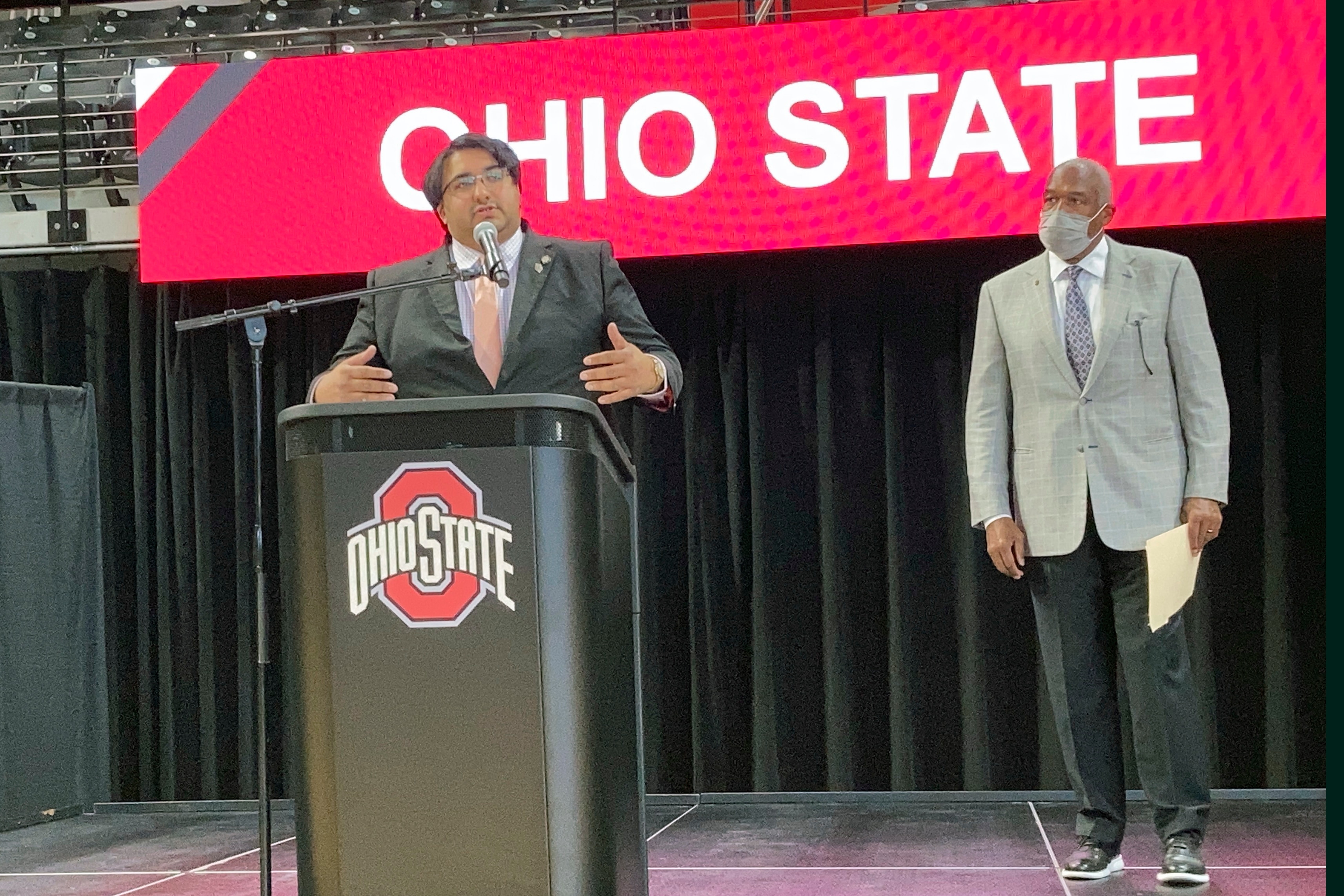 Sen. Niraj Antani, a suburban Dayton Republican, speaks about a bill that would allow athletes at Ohio colleges to earn compensation through endorsements and sponsorship deals based on their names, images and likenesses on Monday, May 24, 2021, in Columbus, Ohio. Looking on at right is Ohio State University Athletics Director Gene Smith.  (AP Photo/Andrew Welsh-Huggins)