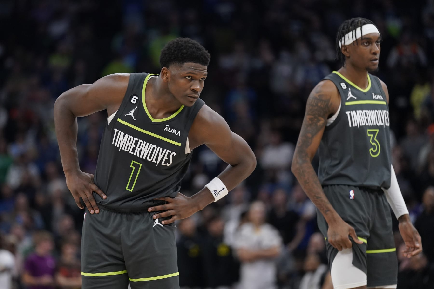Minnesota Timberwolves forward Anthony Edwards (1), left, and forward Jaden McDaniels (3) stand on the court during overtime of an NBA basketball game against the Utah Jazz, Friday, Oct. 21, 2022, in Minneapolis. (AP Photo/Abbie Parr)