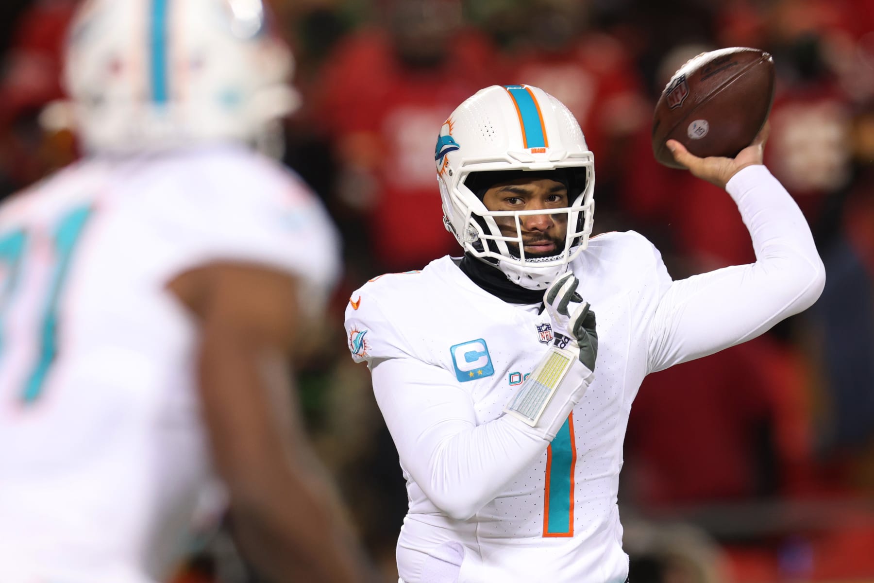 KANSAS CITY, MISSOURI - JANUARY 13: Tua Tagovailoa #1 of the Miami Dolphins looks to throw a pass during the second half against the Kansas City Chiefs in the AFC Wild Card Playoffs at GEHA Field at Arrowhead Stadium on January 13, 2024 in Kansas City, Missouri. (Photo by Jamie Squire/Getty Images)