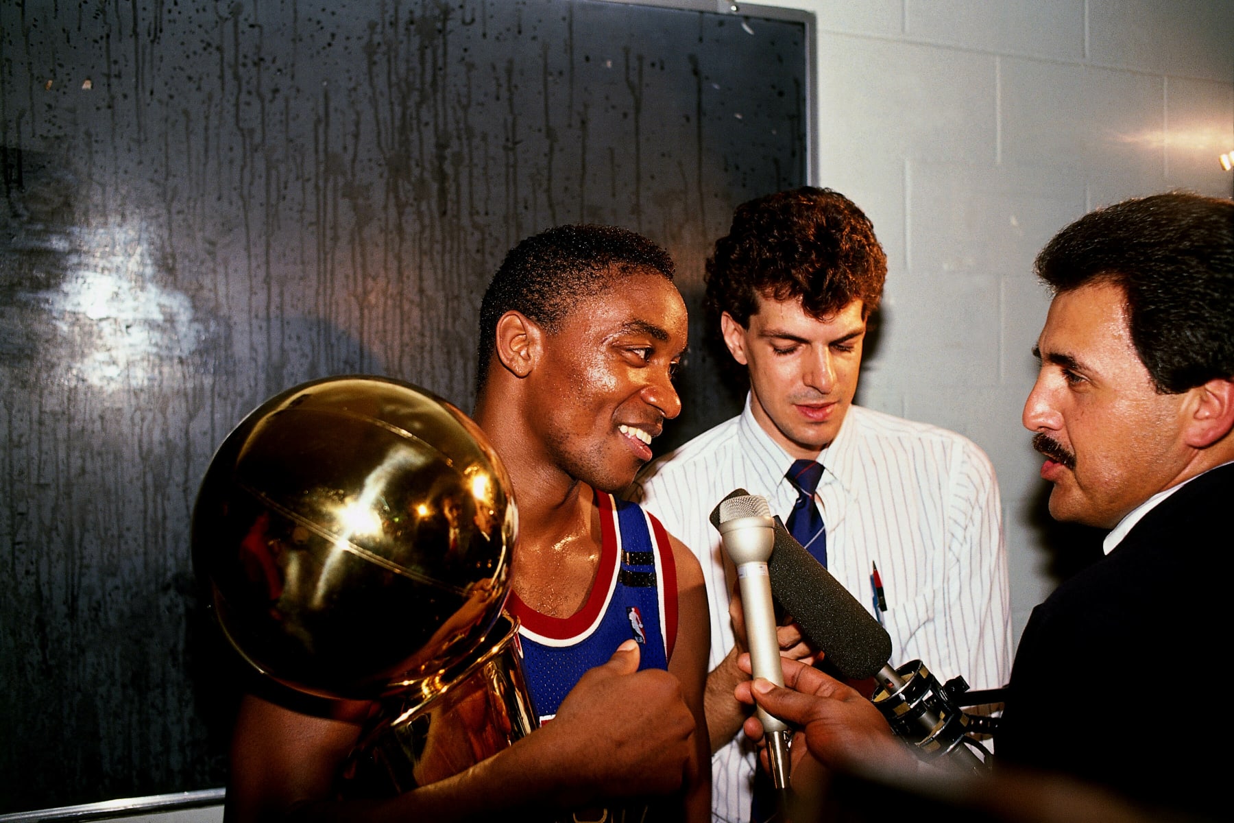 INGLEWOOD, CA - JUNE 13:  Isiah Thomas #11 of the Detroit Pistons holds the Larry O'Brien trophy while being interviewed by reporters. The Detroit Pistons defeated the Los Angeles Lakers to win the 1989 NBA Championship at the Great Western Forum on June 13, 1989 in Inglewood, California.  NOTE TO USER: User expressly acknowledges that, by downloading and or using this photograph, User is consenting to the terms and conditions of the Getty Images License agreement. Mandatory Copyright Notice: Copyright 1989 NBAE (Photo by Nathaniel S. Butler/NBAE via Getty Images)