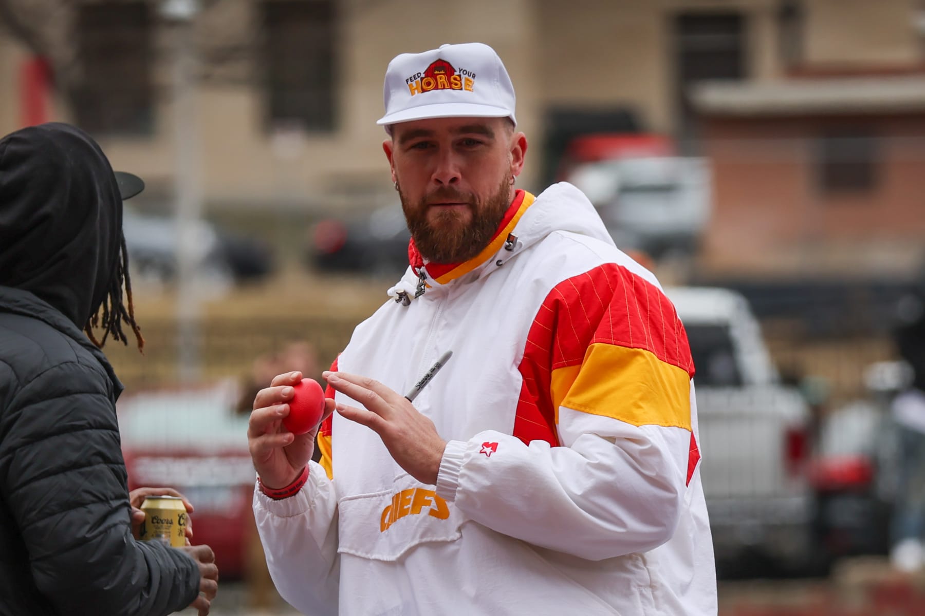 KANSAS CITY, MO - FEBRUARY 15: Kansas City Chiefs tight end Travis Kelce (87) throws a small, autographed ball to fans during the Chiefs Super Bowl LVII Victory Parade on February 15, 2023 in Kansas City, MO. (Photo by Scott Winters/Icon Sportswire via Getty Images)