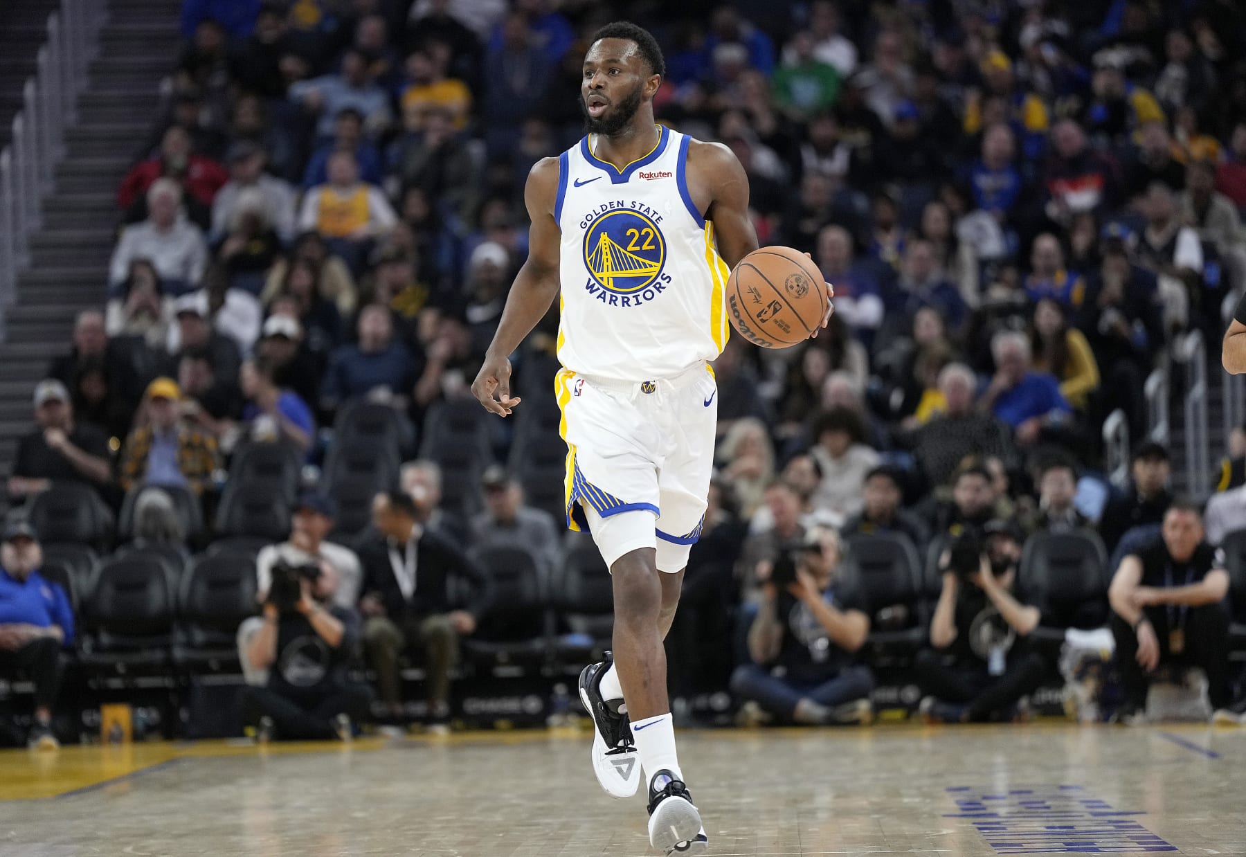 SAN FRANCISCO, CALIFORNIA - DECEMBER 06: Andrew Wiggins #22 of the Golden State Warriors dribbles the ball up court against the Portland Trail Blazers during the third quarter of an NBA basketball game at Chase Center on December 06, 2023 in San Francisco, California. NOTE TO USER: User expressly acknowledges and agrees that, by downloading and or using this photograph, User is consenting to the terms and conditions of the Getty Images License Agreement. (Photo by Thearon W. Henderson/Getty Images)