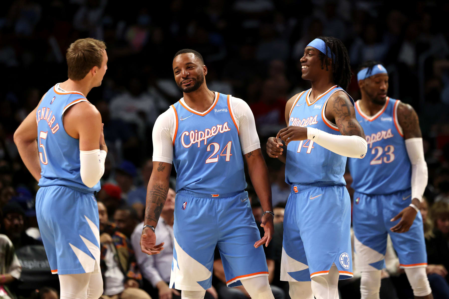 LOS ANGELES, CALIFORNIA - APRIL 09: Luke Kennard #5, Norman Powell #24, and Terance Mann #14 of the Los Angeles Clippers talk during the second half against the Sacramento Kings at Crypto.com Arena on April 09, 2022 in Los Angeles, California. NOTE TO USER: User expressly acknowledges and agrees that, by downloading and or using this photograph, User is consenting to the terms and conditions of the Getty Images License Agreement. (Photo by Katelyn Mulcahy/Getty Images)