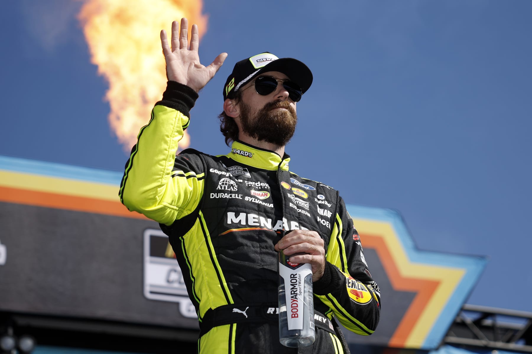 AVONDALE, ARIZONA - NOVEMBER 05: Ryan Blaney, driver of the #12 Menards/Dutch Boy Ford, waves to fans onstage during driver intros prior to the NASCAR Cup Series Championship at Phoenix Raceway on November 05, 2023 in Avondale, Arizona. (Photo by James Gilbert/Getty Images)