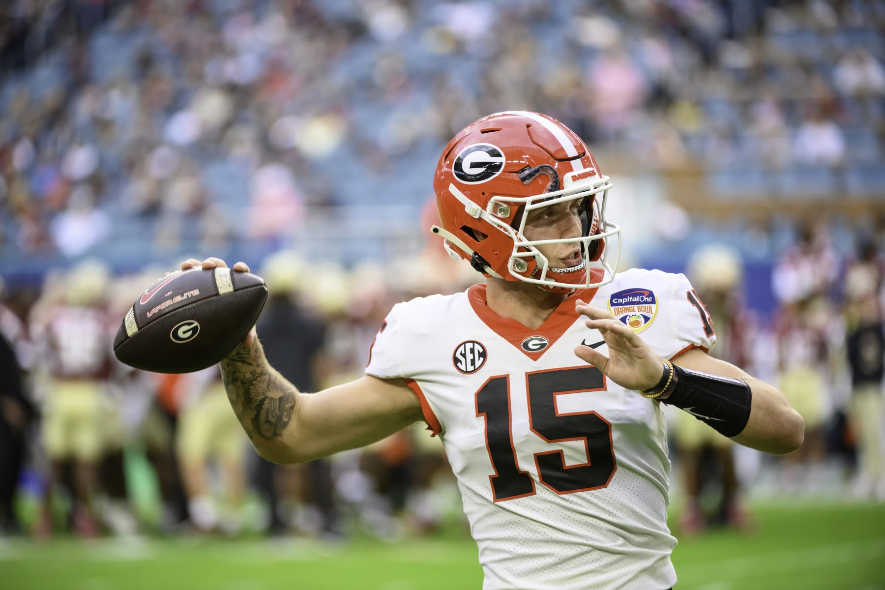 MIAMI GARDENS, FL - DECEMBER 30: Georgia quarterback Carson Beck (15) throws the football on the field as he warms up during the Capital One Orange Bowl college football game between the Georgia Bulldogs and the Florida State Seminoles on December 30, 2023 at the Hard Rock Stadium in Miami Gardens, FL. (Photo by Doug Murray/Icon Sportswire via Getty Images)