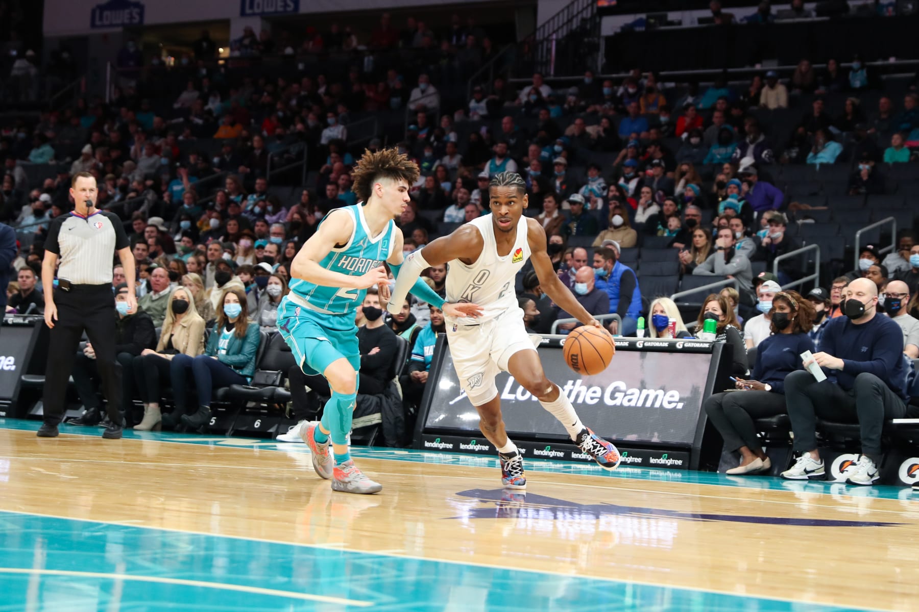 CHARLOTTE, NC - JANUARY 21: Shai Gilgeous-Alexander #2 of the Oklahoma City Thunder handles the ball as LaMelo Ball #2 of the Charlotte Hornets plays defense during the game on January 21, 2022 at Spectrum Center in Charlotte, North Carolina. NOTE TO USER: User expressly acknowledges and agrees that, by downloading and or using this photograph, User is consenting to the terms and conditions of the Getty Images License Agreement.  Mandatory Copyright Notice:  Copyright 2022 NBAE (Photo by Brock Williams-Smith/NBAE via Getty Images)