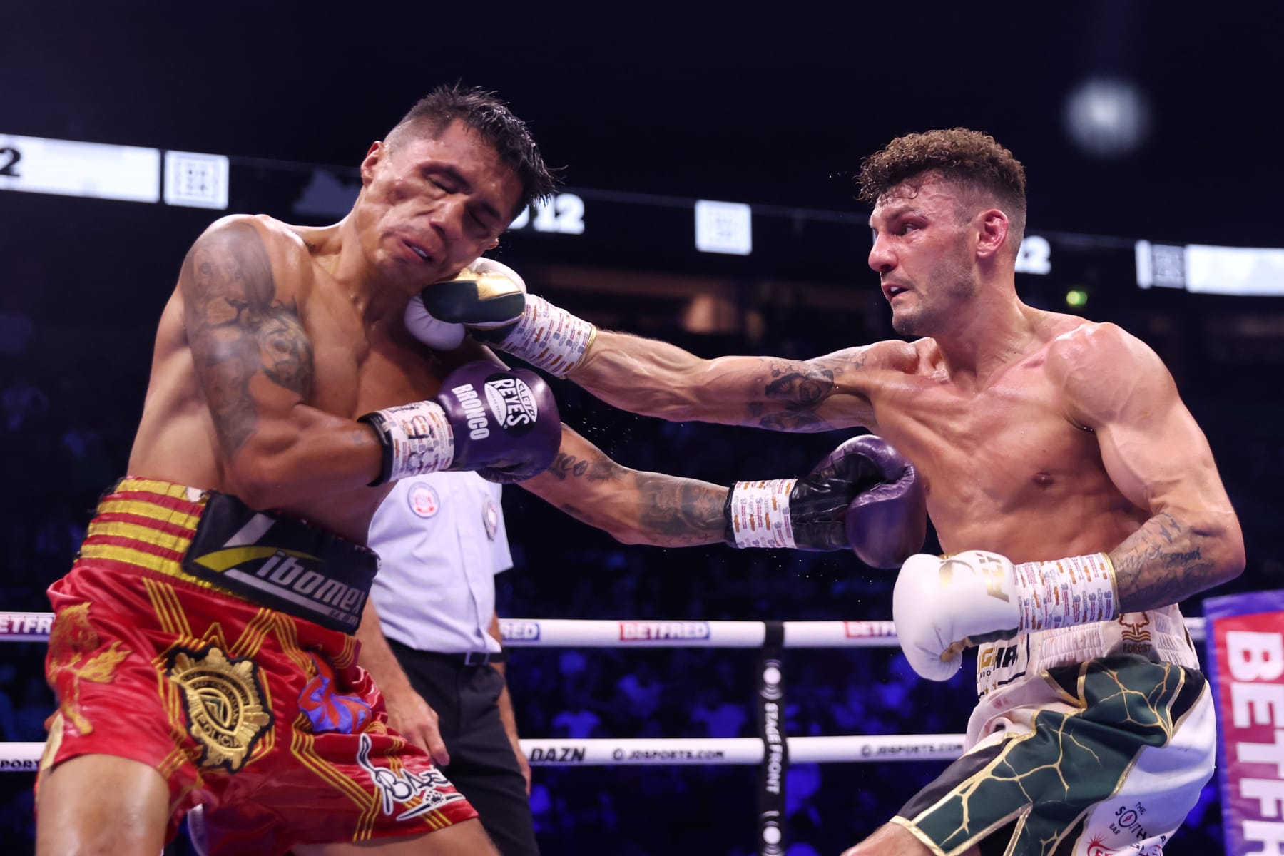 MANCHESTER, ENGLAND - MAY 27: Leigh Wood punches Mauricio Lara during their WBA World Featherweight Title Fight at AO Arena on May 27, 2023 in Manchester, England. (Photo by Nathan Stirk/Getty Images)