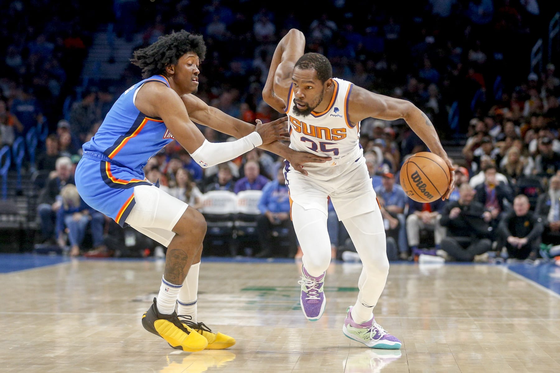 OKLAHOMA CITY, OKLAHOMA - APRIL 02: Kevin Durant #35 of the Phoenix Suns drives past Jalen Williams #8 of the Oklahoma City Thunder during the second quarter at Paycom Center on April 02, 2023 in Oklahoma City, Oklahoma. NOTE TO USER: User expressly acknowledges and agrees that, by downloading and or using this photograph, User is consenting to the terms and conditions of the Getty Images License Agreement.  (Photo by Ian Maule/Getty Images)