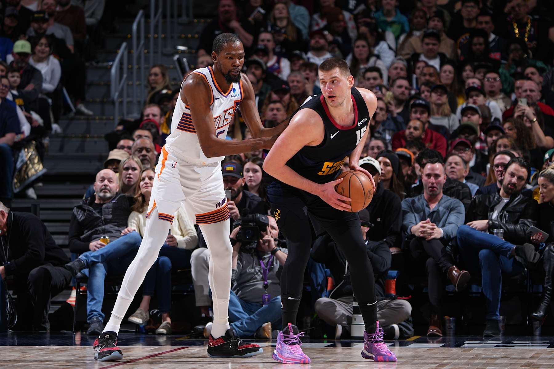 DENVER, CO - MARCH 27: Nikola Jokic #15 of the Denver Nuggets handles the ball during the game against the Phoenix Suns on March 27, 2023 at the Ball Arena in Denver, Colorado. NOTE TO USER: User expressly acknowledges and agrees that, by downloading and/or using this Photograph, user is consenting to the terms and conditions of the Getty Images License Agreement. Mandatory Copyright Notice: Copyright 2024 NBAE (Photo by Garrett Ellwood/NBAE via Getty Images)
