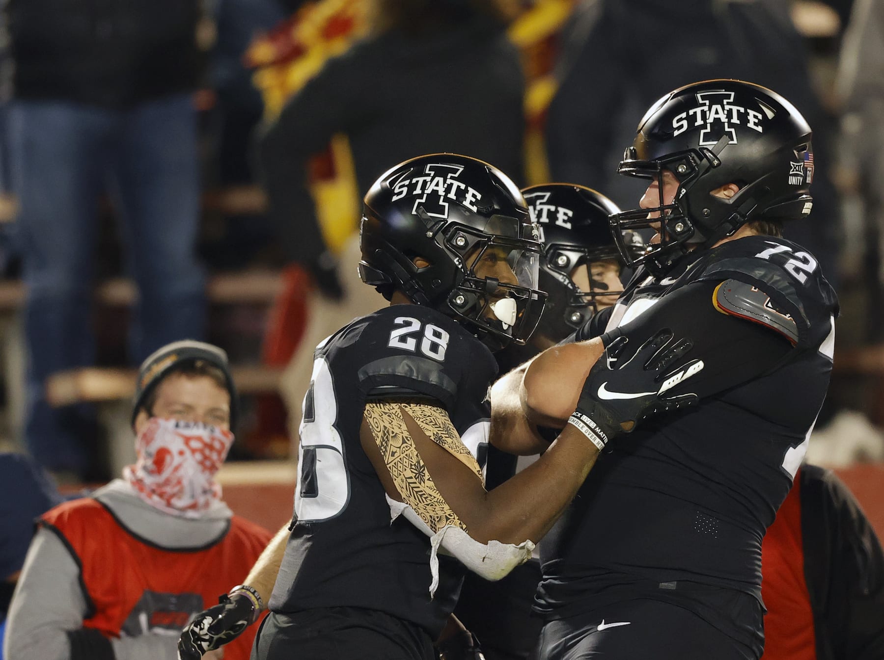 Iowa State running back Breece Hall, left, celebrates his touchdown with offensive lineman Jake Remsburg, right, during the second half of an NCAA college football game against West Virginia on Saturday, Dec. 5, 2020, in Ames, Iowa. (AP Photo/Matthew Putney)