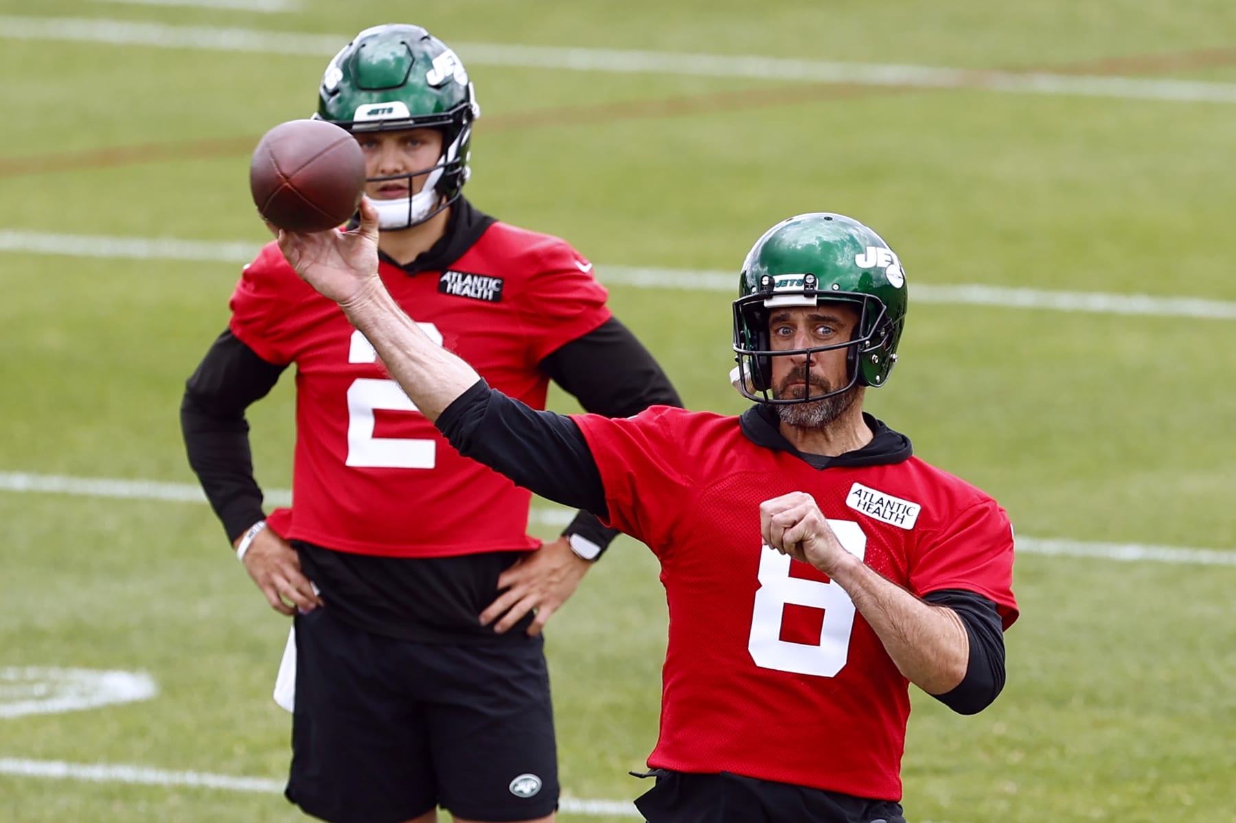 FLORHAM PARK, NEW JERSEY - JUNE 9: Quarterback Aaron Rodgers #8 of the New York Jets attempts a pass as Zach Wilson #2 looks on during the team's OTA's at Atlantic Health Jets Training Center on June 9, 2023 in Florham Park, New Jersey. (Photo by Rich Schultz/Getty Images)
