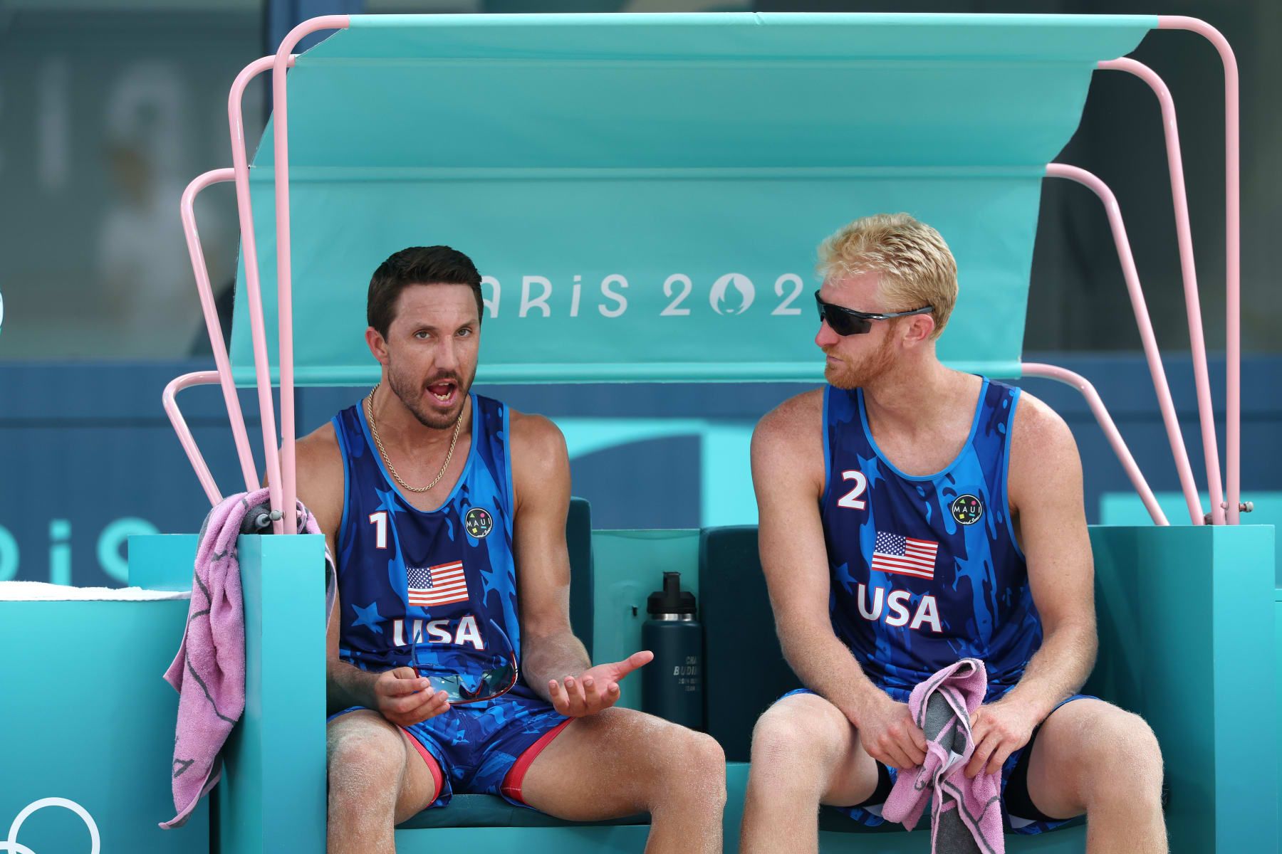 PARIS, FRANCE - AUGUST 02: Miles Evans and Chase Budinger of Team United States react on the bench after losing a Men's Preliminary Phase match to Team Spain on day seven of the Olympic Games Paris 2024 at Eiffel Tower Stadium on August 02, 2024 in Paris, France. (Photo by Elsa/Getty Images)