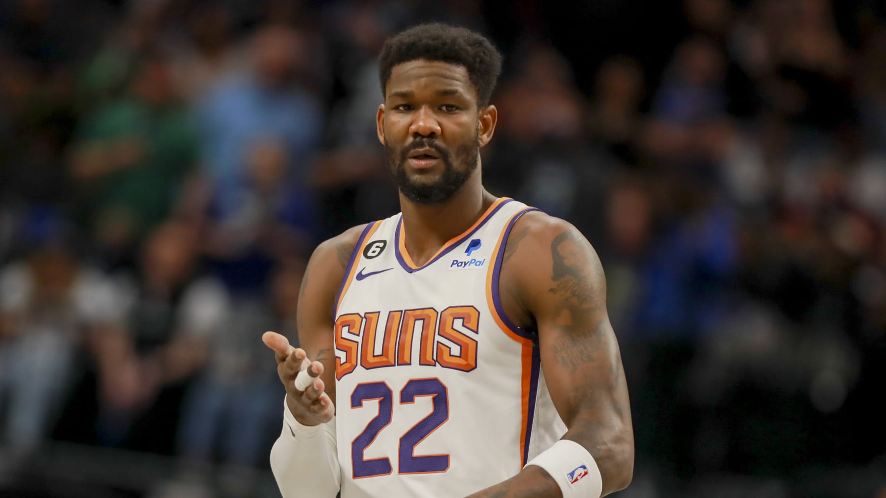 Phoenix Suns center Deandre Ayton (22) talks to a teammate during a free throw attempt during an NBA basketball game against the Dallas Mavericks, Sunday, March 5, 2023, in Dallas. (AP Photo/Gareth Patterson)