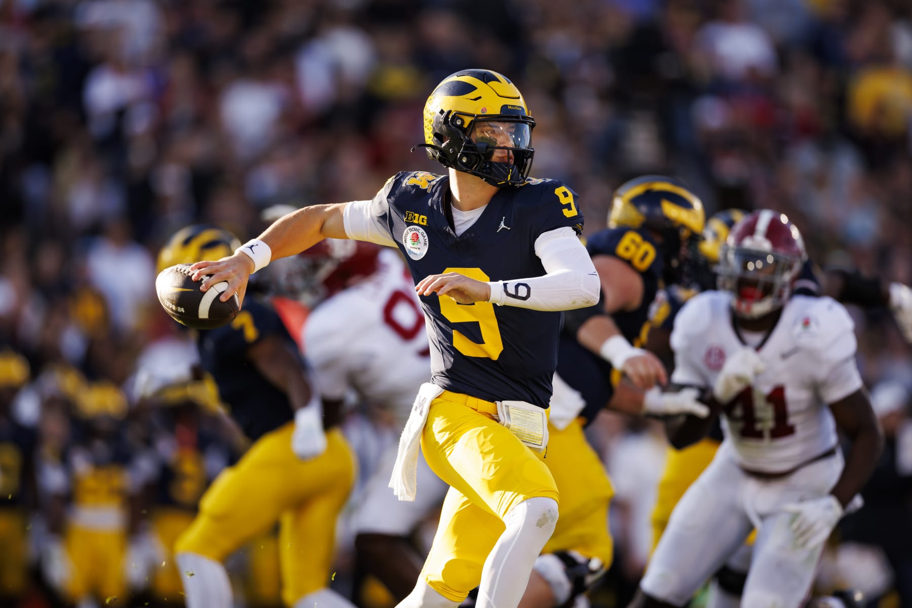PASADENA, CALIFORNIA - JANUARY 01: Quarterback J.J. McCarthy #9 of the Michigan Wolverines rolls out and looks to throw a pass during the CFP Semifinal Rose Bowl Game against the Alabama Crimson Tide at Rose Bowl Stadium on January 1, 2024 in Pasadena, California. (Photo by Ryan Kang/Getty Images)