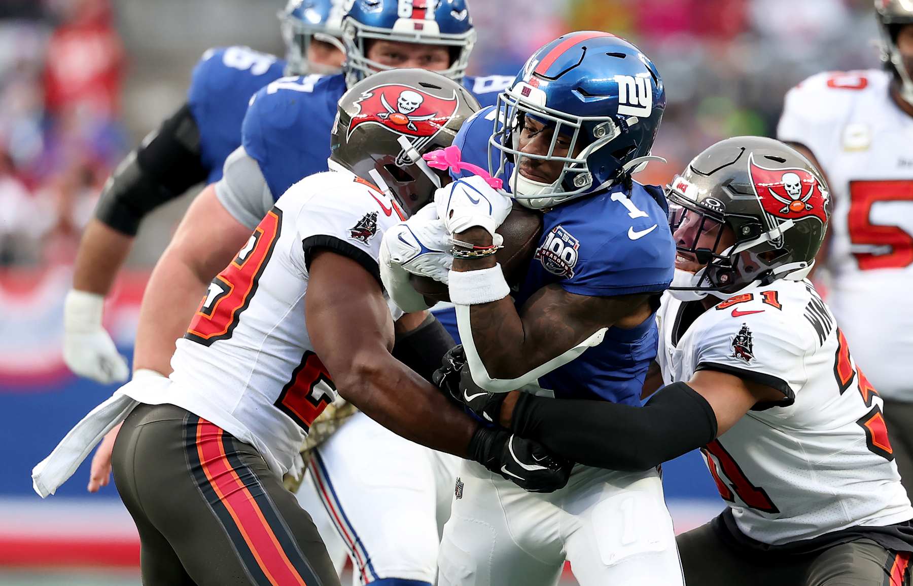 EAST RUTHERFORD, NEW JERSEY - NOVEMBER 24: Malik Nabers #1 of the New York Giants carries the ball as Christian Izien #29 and Antoine Winfield Jr. #31 of the Tampa Bay Buccaneers defend at MetLife Stadium on November 24, 2024 in East Rutherford, New Jersey. (Photo by Elsa/Getty Images)