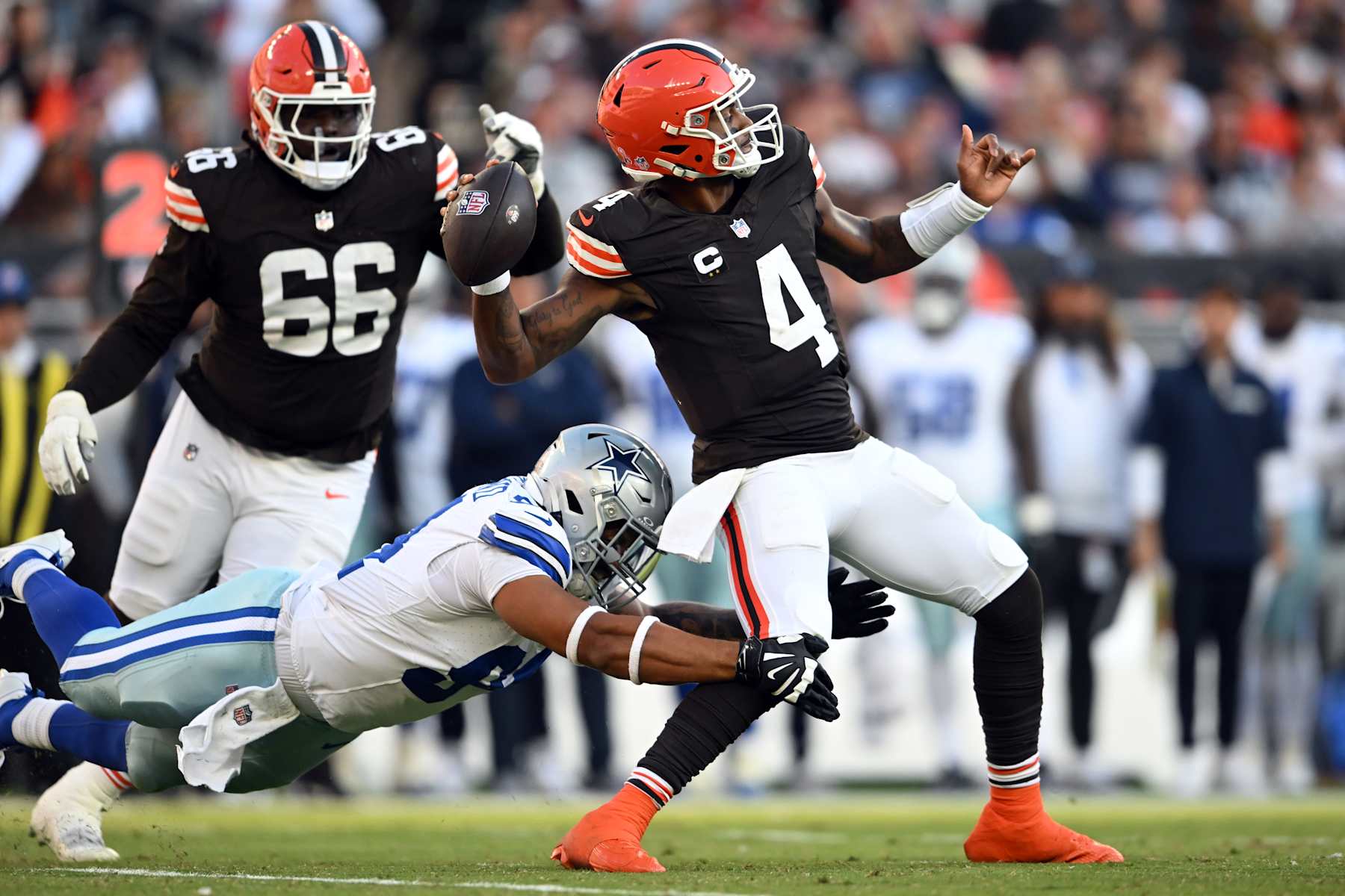 CLEVELAND, OHIO - SEPTEMBER 08: Deshaun Watson #4 of the Cleveland Browns is hit by Marshawn Kneeland #94 of the Dallas Cowboys as he throws the ball in the third quarter of the game at Cleveland Browns Stadium on September 08, 2024 in Cleveland, Ohio. (Photo by Nick Cammett/Getty Images)