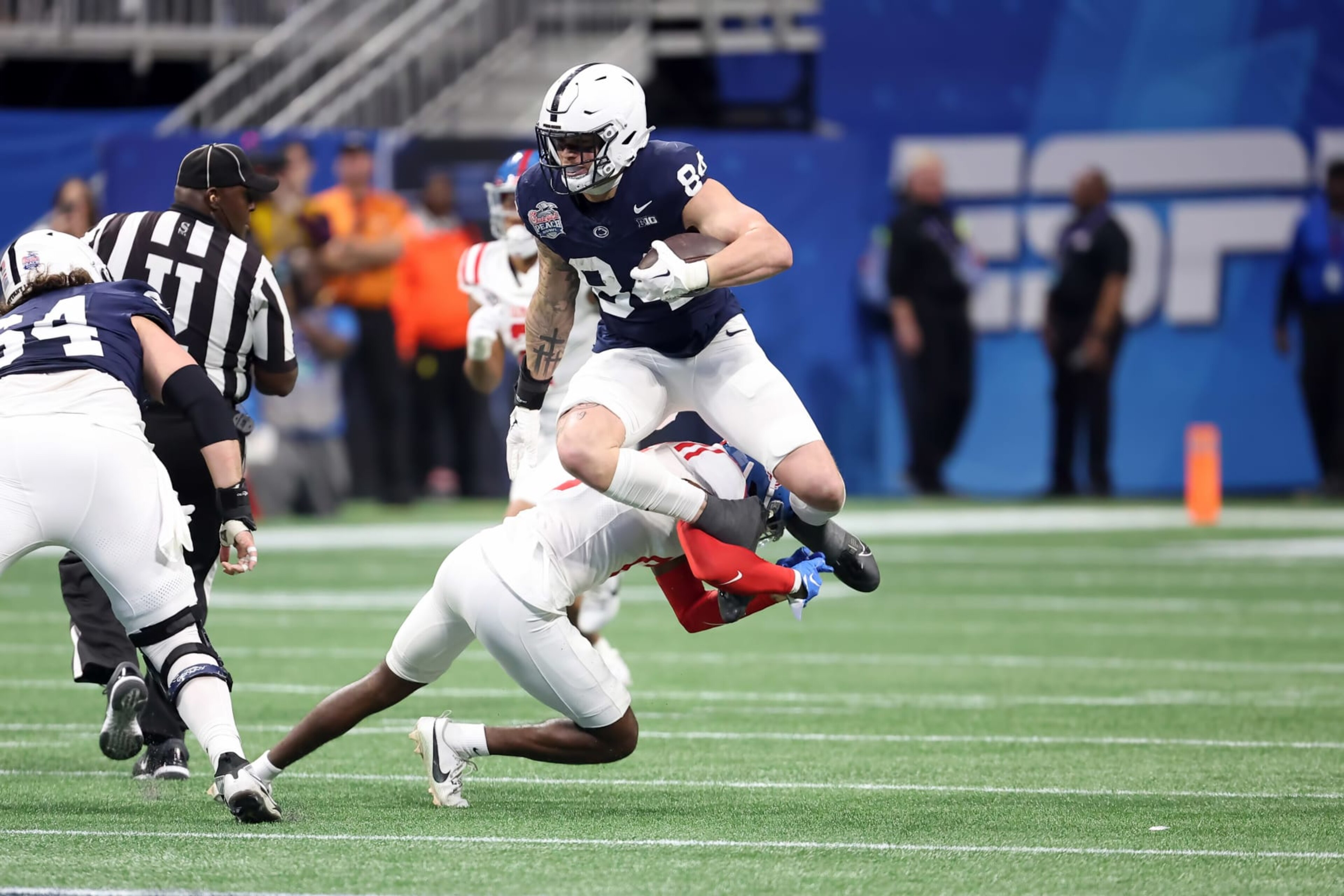 ATLANTA, GA - DECEMBER 30: Penn State Nittany Lions tight end Theo Johnson (84) leaps a defender during the Chick-fil-A Peach Bowl between the Penn State Nittany Lions and the Mississippi Rebels on December 30, 2023 at Mercedes-Benz Stadium in Atlanta, Georgia.  (Photo by Michael Wade/Icon Sportswire via Getty Images)