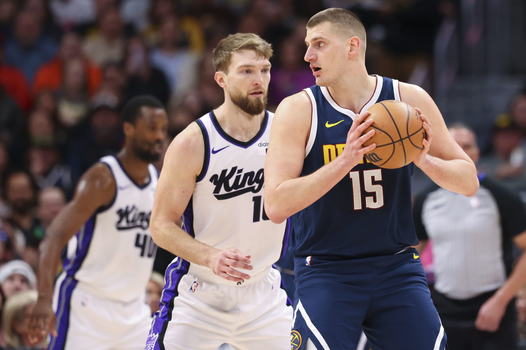 DENVER, COLORADO - FEBRUARY 14: Nikola Jokic #15 of the Denver Nuggets looks for a pass while Domantas Sabonis #10 of the Sacramento Kings defends during the game at Ball Arena on February 14, 2024 in Denver, Colorado. NOTE TO USER: User expressly acknowledges and agrees that, by downloading and or using this photograph, User is consenting to the terms and conditions of the Getty Images License Agreement. (Photo by Alysa Rubin/Clarkson Creative/Getty Images)