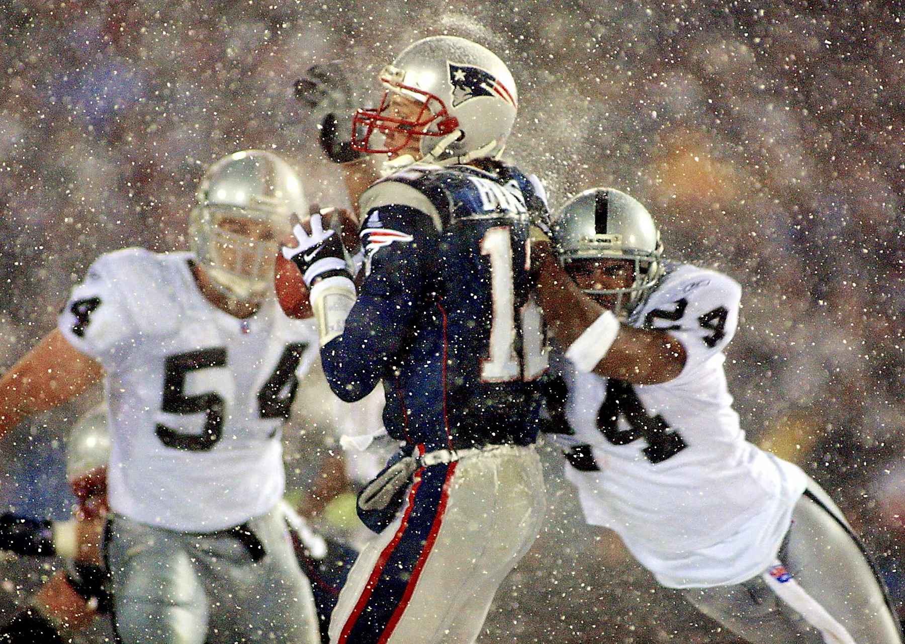 Tom Brady (center) and Charles Woodson (right)