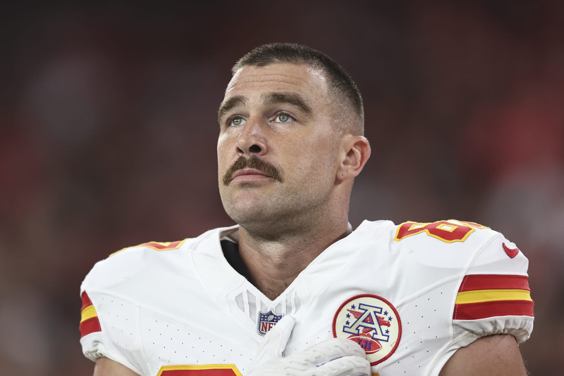 GLENDALE, ARIZONA - AUGUST 19: Travis Kelce #87 of the Kansas City Chiefs looks on during the national anthem prior to an NFL preseason football game between the Arizona Cardinals and the Kansas City Chiefs at State Farm Stadium on August 19, 2023 in Glendale, Arizona. (Photo by Michael Owens/Getty Images)