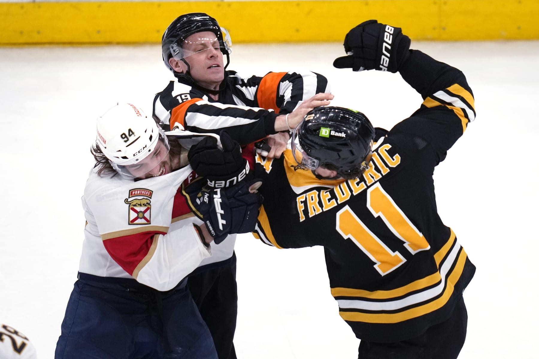 Boston Bruins center Trent Frederic (11) fights Florida Panthers left wing Ryan Lomberg (94) during the final seconds in Game 2 in the first-round series of the NHL hockey playoffs Wednesday, April 19, 2023, in Boston. The Panthers defeated the Bruins 6-3. (AP Photo/Charles Krupa)
