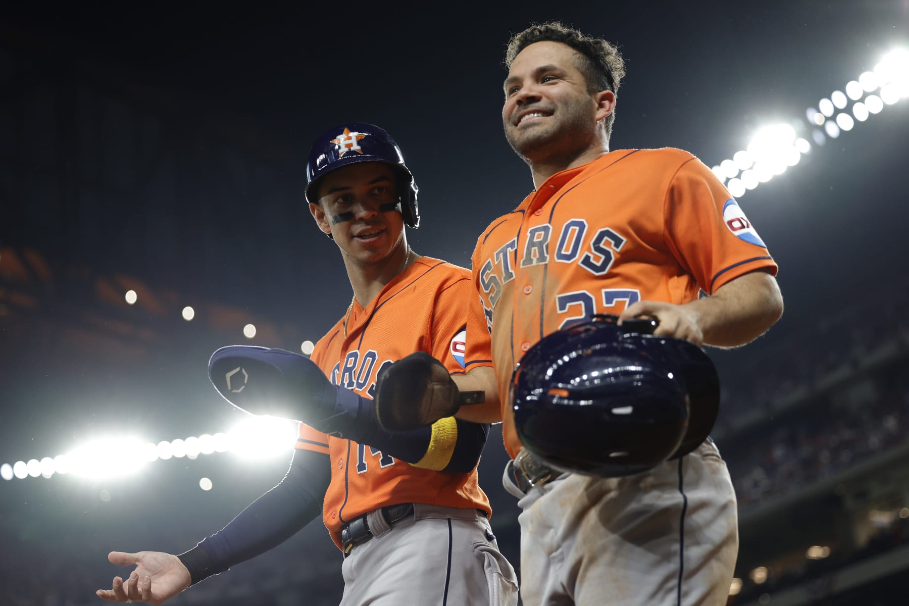 ARLINGTON, TEXAS - OCTOBER 19: Mauricio Dubón #14 and Jose Altuve #27 of the Houston Astros celebrate after scoring runs in the fourth inning against the Texas Rangers during Game Four of the Championship Series at Globe Life Field on October 19, 2023 in Arlington, Texas. (Photo by Carmen Mandato/Getty Images)