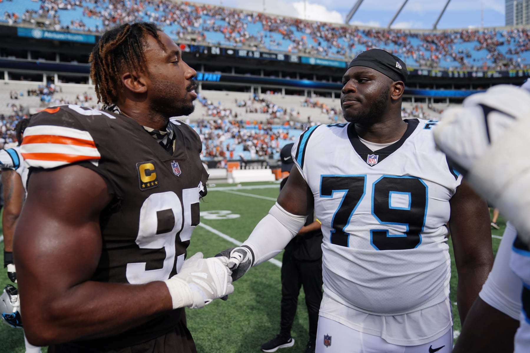 Cleveland Browns defensive end Myles Garrett and Carolina Panthers offensive tackle Ikem Ekwonu meet on the field loss a loss by the Panthers in an NFL football game on Sunday, Sept. 11, 2022, in Charlotte, N.C. (AP Photo/Jacob Kupferman)