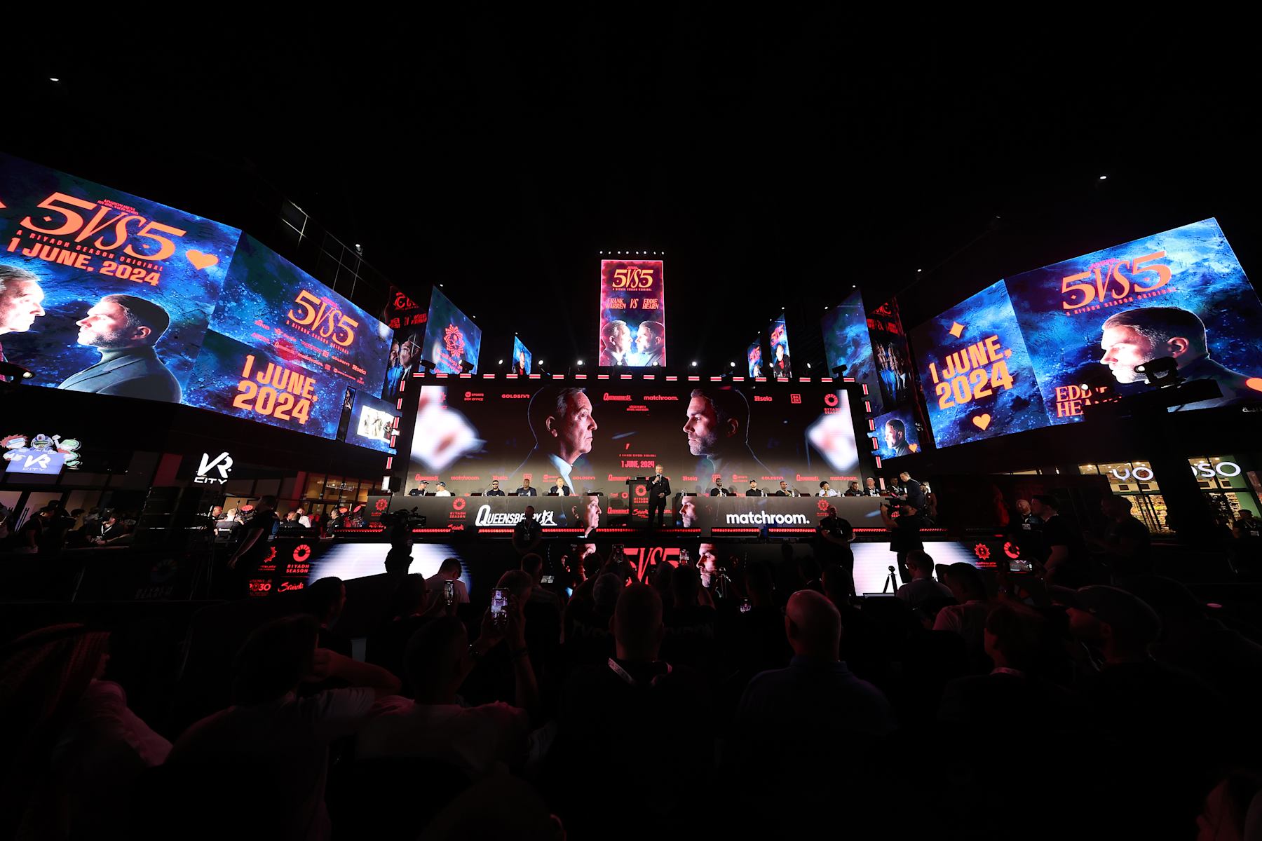 RIYADH, SAUDI ARABIA - MAY 30: A general view inside the venue as Michael Buffer, American Ring Announcer, addresses the crowd during the Queensbury v Matchroom 5v5 Press Conferences at Boulevard World  on May 30, 2024 in Riyadh, Saudi Arabia. (Photo by Richard Pelham/Getty Images)