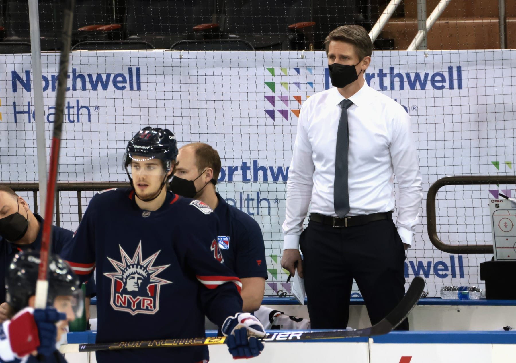 NEW YORK, NEW YORK - MARCH 17: Handling coaching duties for the New York Rangers against the Philadelphia Flyers are Hartford Wolf Pack Head Coach Kris Knoblauch (seen here watching warm-ups), Wolf Pack Associate Head Coach Gord Murphy and Rangers Associate General Manager Chris Drury. Due to the NHL COVID-10 protocol, the Rangers coaching staff were not available for tonights game.  at Madison Square Garden on March 17, 2021 in New York City. (Photo by Bruce Bennett/Getty Images)