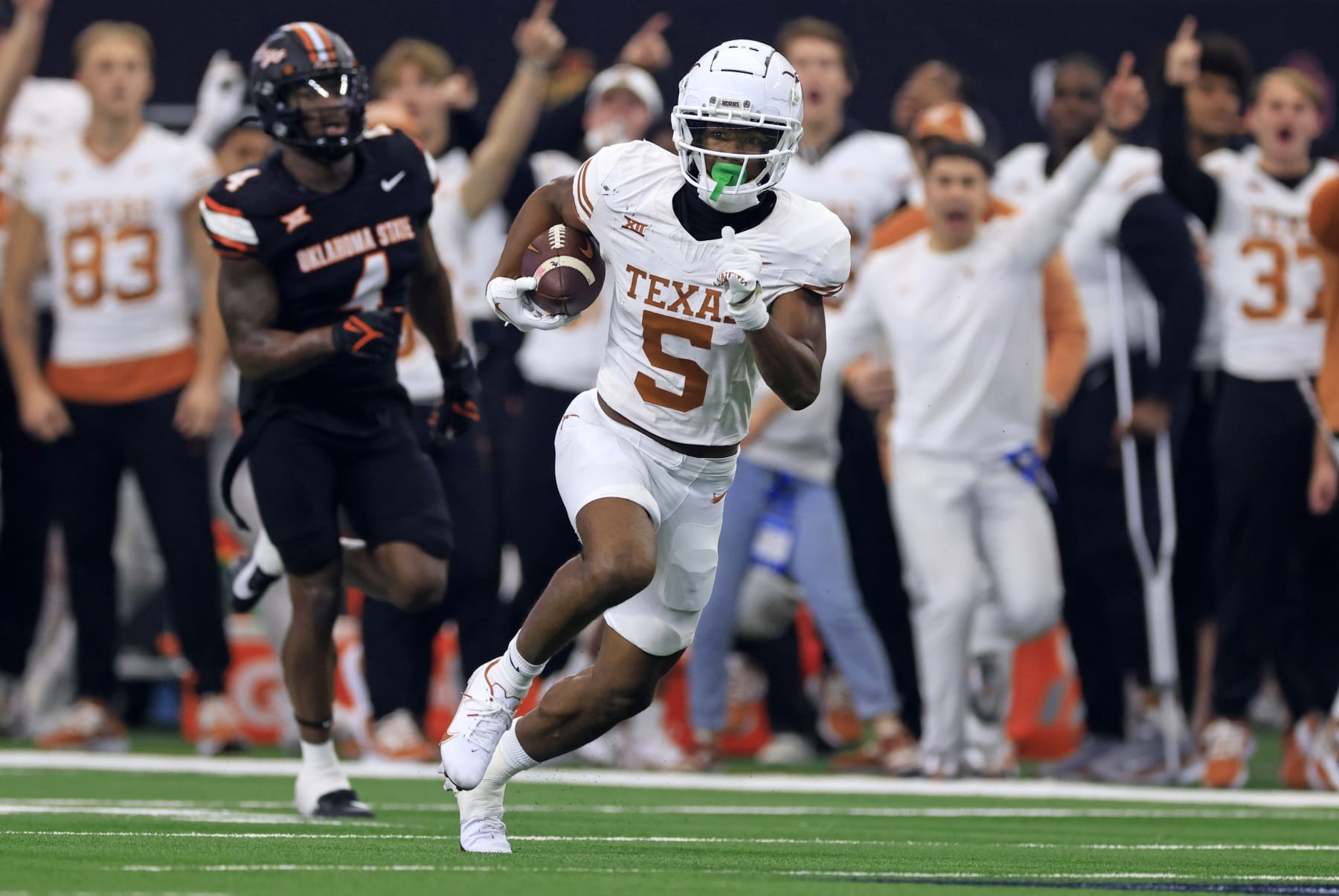 ARLINGTON, TX - DECEMBER 2: Wide receiver Adonai Mitchell #5 of the Texas Longhorns carries the ball against the Oklahoma State Cowboys in the first half of the Big 12  Championship at AT&T Stadium on December 2, 2023 in Arlington, Texas.  (Photo by Ron Jenkins/Getty Images)