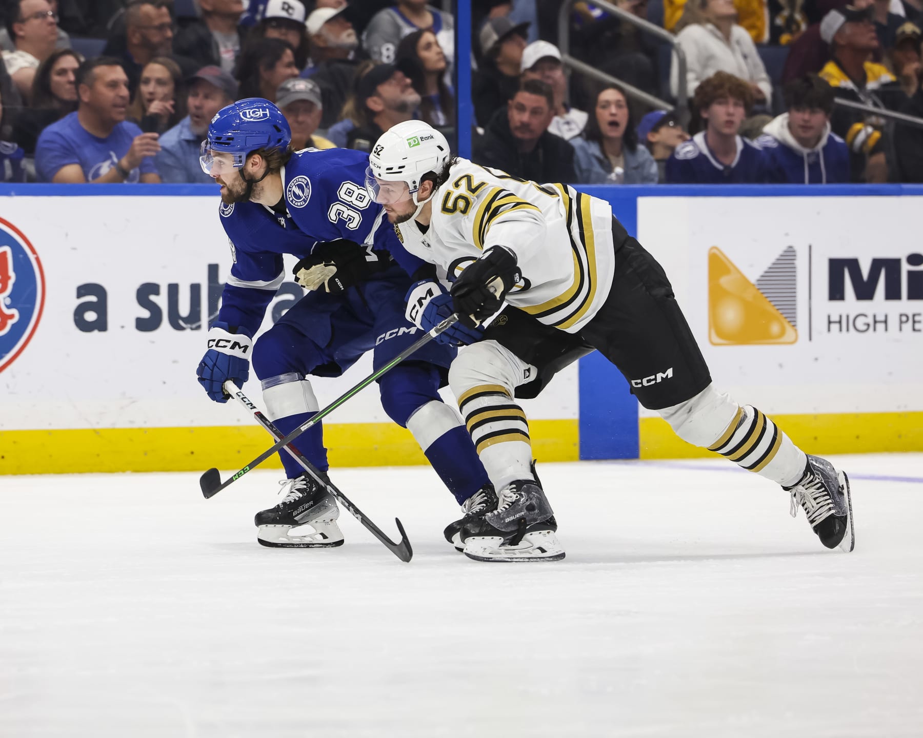 TAMPA, FL - MARCH 27: Brandon Hagel #38 of the Tampa Bay Lightning against Andrew Peeke #52 of the Boston Bruins during the third period at Amalie Arena on March 27, 2024 in Tampa, Florida. (Photo by Mark LoMoglio/NHLI via Getty Images)