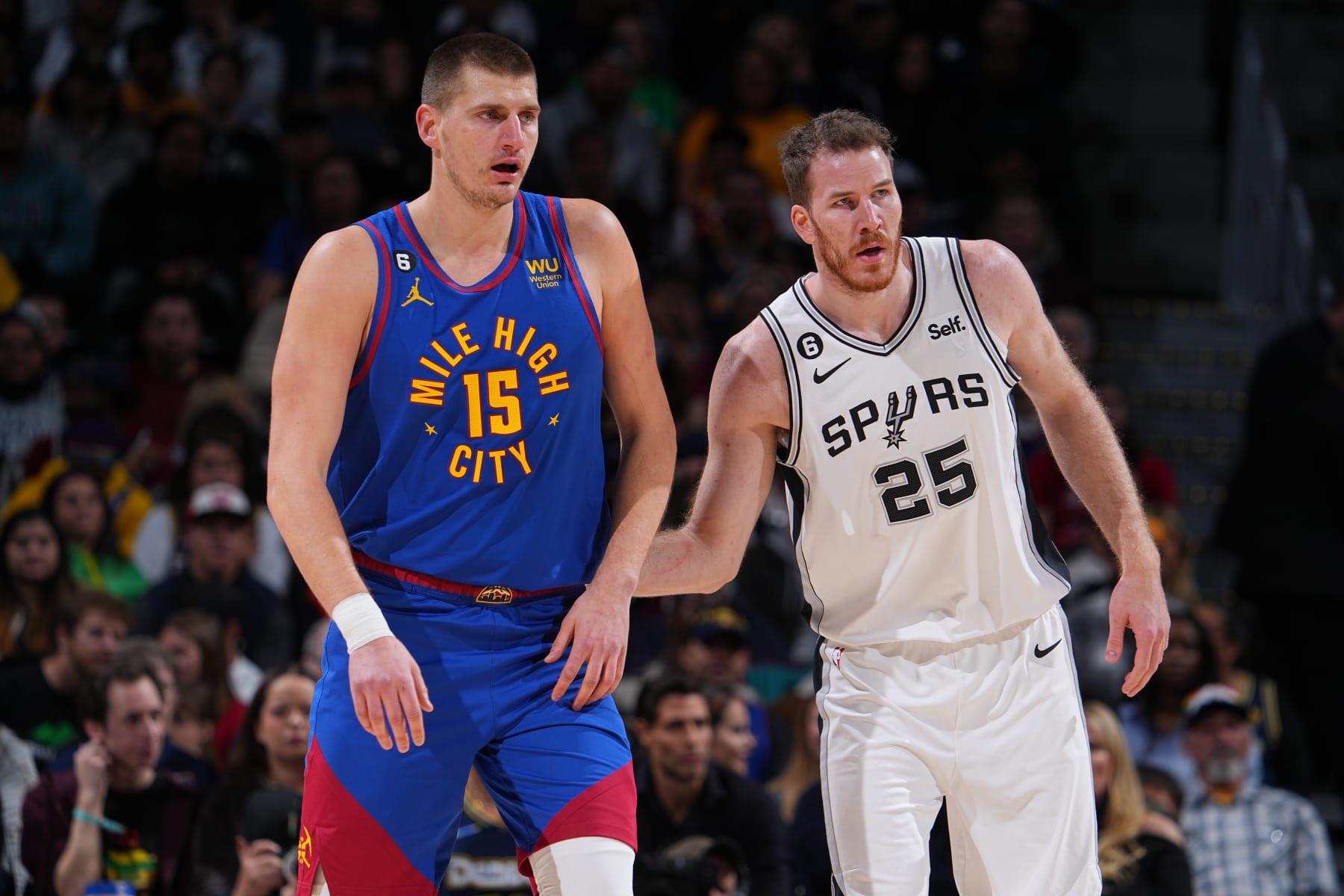DENVER, CO - NOVEMBER 5: Nikola Jokic #15 of the Denver Nuggets and Jakob Poeltl #25 of the San Antonio Spurs look on during the game on November 5, 2022 at the Ball Arena in Denver, Colorado. NOTE TO USER: User expressly acknowledges and agrees that, by downloading and/or using this Photograph, user is consenting to the terms and conditions of the Getty Images License Agreement. Mandatory Copyright Notice: Copyright 2022 NBAE (Photo by Bart Young/NBAE via Getty Images)