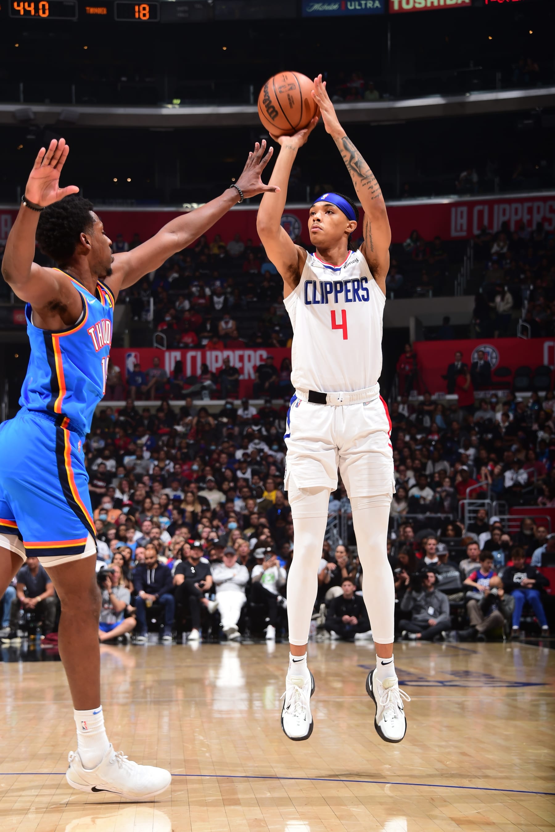 LOS ANGELES, CA - APRIl 10: Brandon Boston Jr. #4 of the LA Clippers shoots a three point basket during the game against the Oklahoma City Thunder on April 10, 2022 at Crypto.Com Arena in Los Angeles, California. NOTE TO USER: User expressly acknowledges and agrees that, by downloading and/or using this Photograph, user is consenting to the terms and conditions of the Getty Images License Agreement. Mandatory Copyright Notice: Copyright 2022 NBAE (Photo by Adam Pantozzi/NBAE via Getty Images)