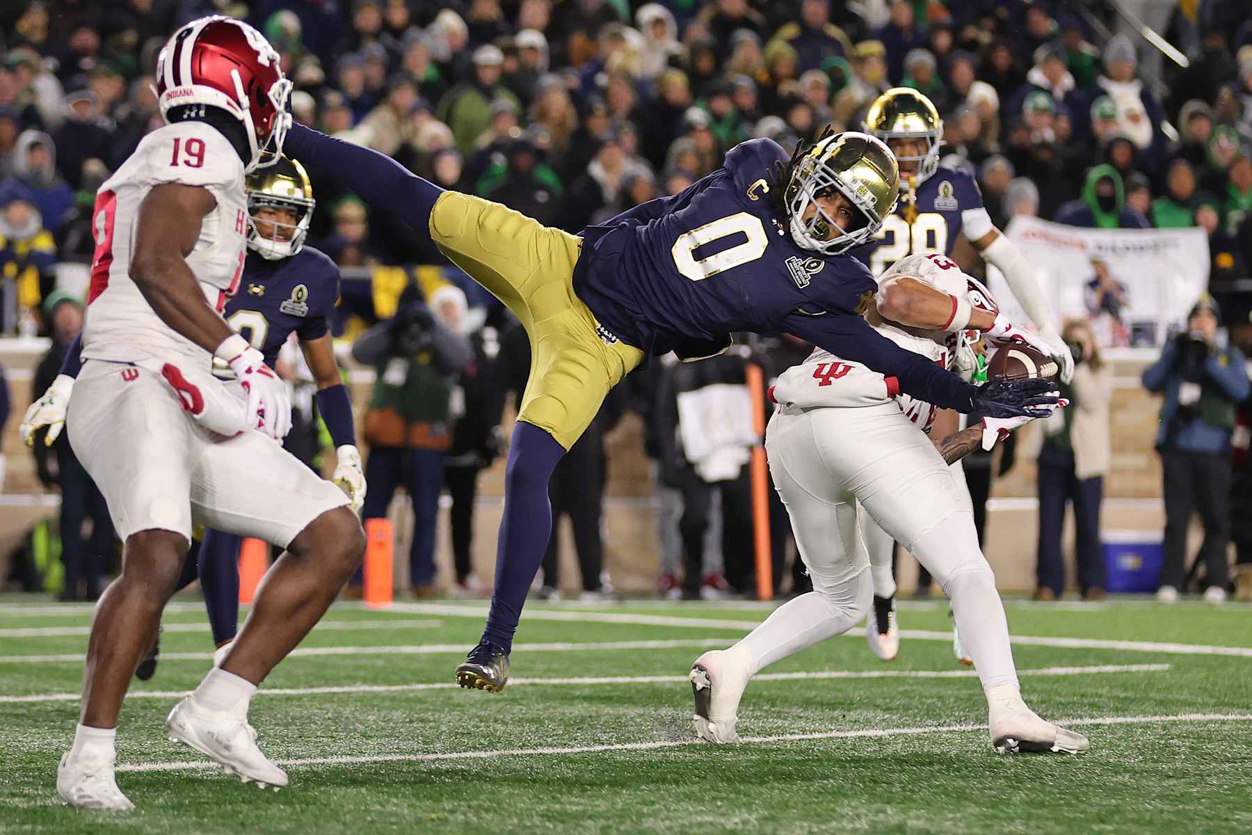 SOUTH BEND, INDIANA - DECEMBER 20: Elijah Sarratt #13 of the Indiana Hoosiers catches a 2-point conversion against Xavier Watts #0 of the Notre Dame Fighting Irish during the fourth quarter in the Playoff First Round game at Notre Dame Stadium on December 20, 2024 in South Bend, Indiana. Notre Dame defeated Indiana 27-17. (Photo by Michael Reaves/Getty Images)