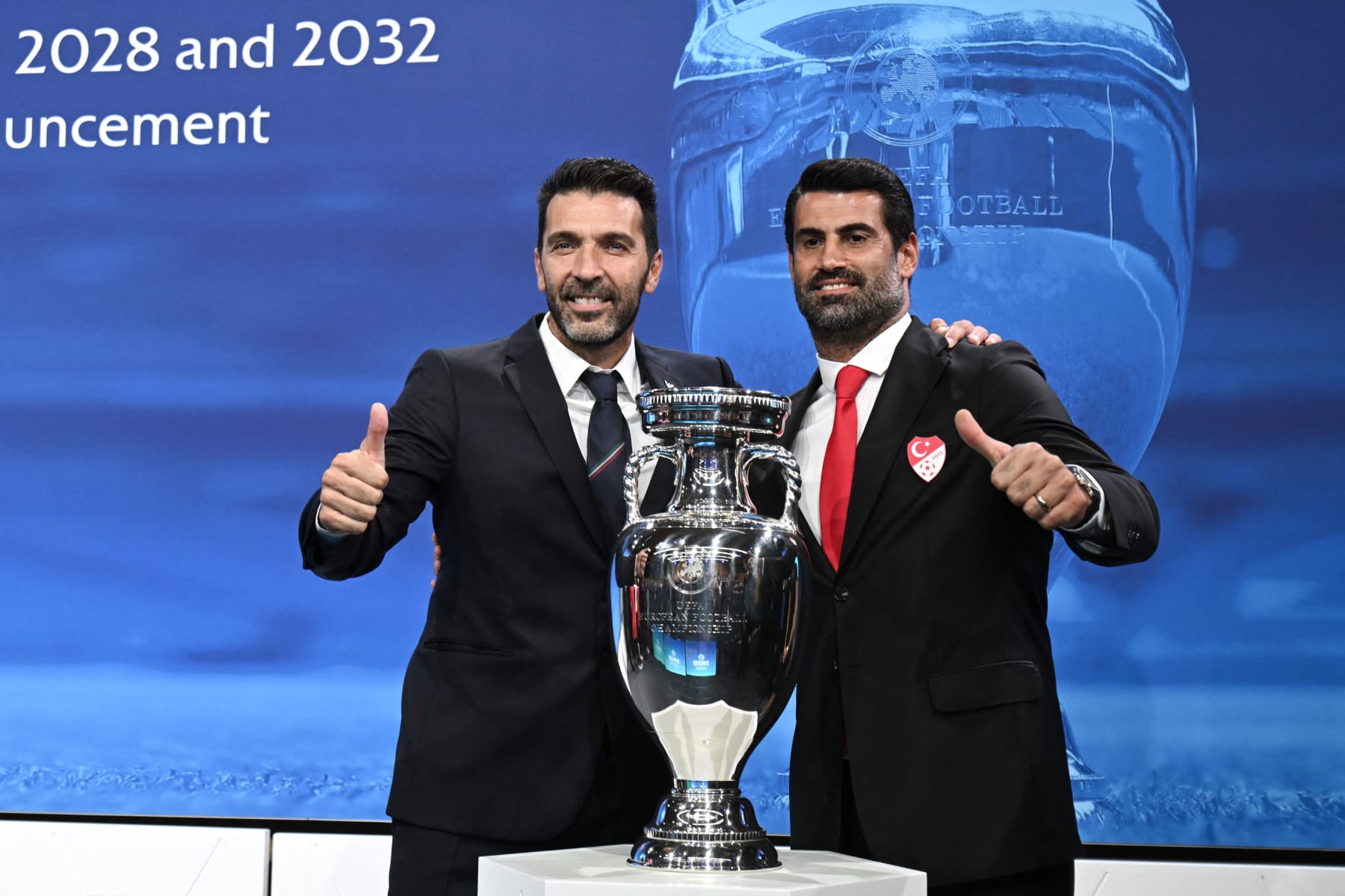 Head of Italian delegation and Italian former professional football player Gianluigi Buffon (L) and Turkish coach, former football player and head of the ambassador of the Turkish delegation Volkan Demirel (R) react after Italy and Turkey were elected to host the Euro 2032 fooball tournament during the announcement ceremony at the UEFA headquarters in Nyon on October 10, 2023. (Photo by Fabrice COFFRINI / AFP) (Photo by FABRICE COFFRINI/AFP via Getty Images)
