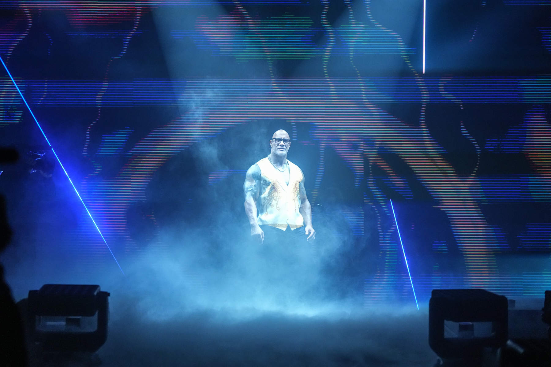 LOS ANGELES, CALIFORNIA - JANUARY 7: The Rock makes his entrance during NXT: New Year's Evil at The Shrine Expo Hall on January 7, 2025 in Los Angeles, California.  (Photo by WWE/Getty Images)
