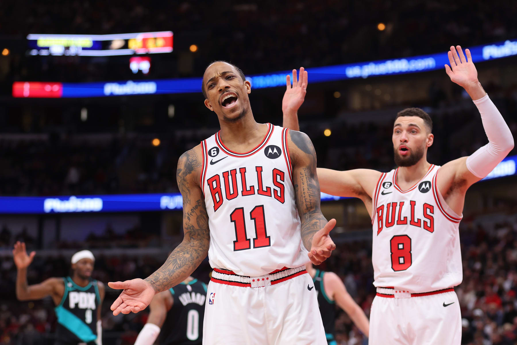 CHICAGO, ILLINOIS - FEBRUARY 04: DeMar DeRozan #11 and Zach LaVine #8 of the Chicago Bulls react to a foul call against the Portland Trail Blazers during the first half at United Center on February 04, 2023 in Chicago, Illinois. NOTE TO USER: User expressly acknowledges and agrees that, by downloading and or using this photograph, User is consenting to the terms and conditions of the Getty Images License Agreement.  (Photo by Michael Reaves/Getty Images)
