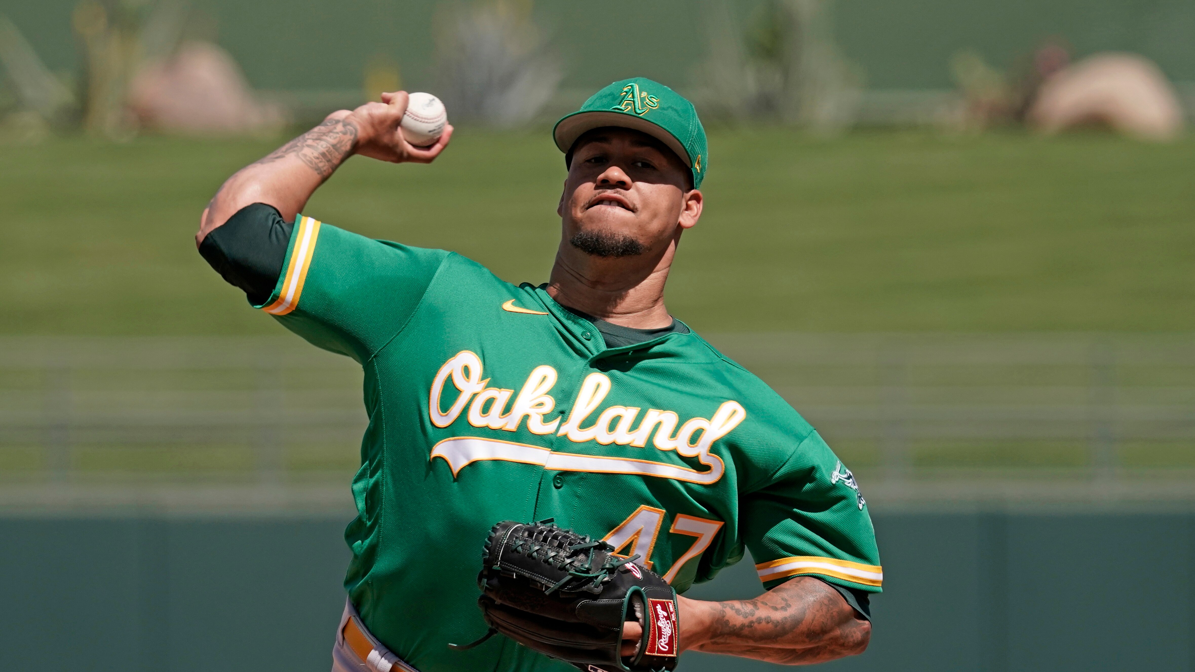 Oakland Athletics starting pitcher Frankie Montas throws during the first inning of a spring training baseball game against the Kansas City Royals Tuesday, March 22, 2022, in Surprise, Ariz. (AP Photo/Charlie Riedel)