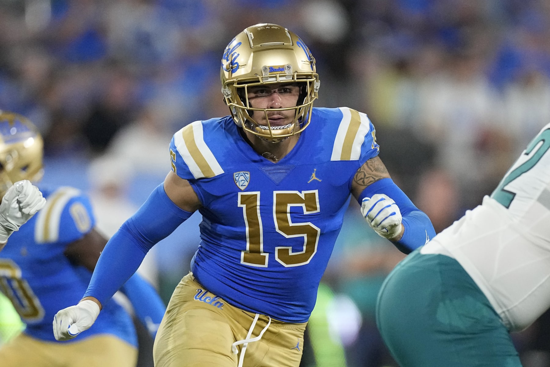 UCLA defensive lineman Laiatu Latu runs a play during the first half of an NCAA college football game against Coastal Carolina Saturday, Sept. 2, 2023, in Pasadena, Calif. (AP Photo/Mark J. Terrill)