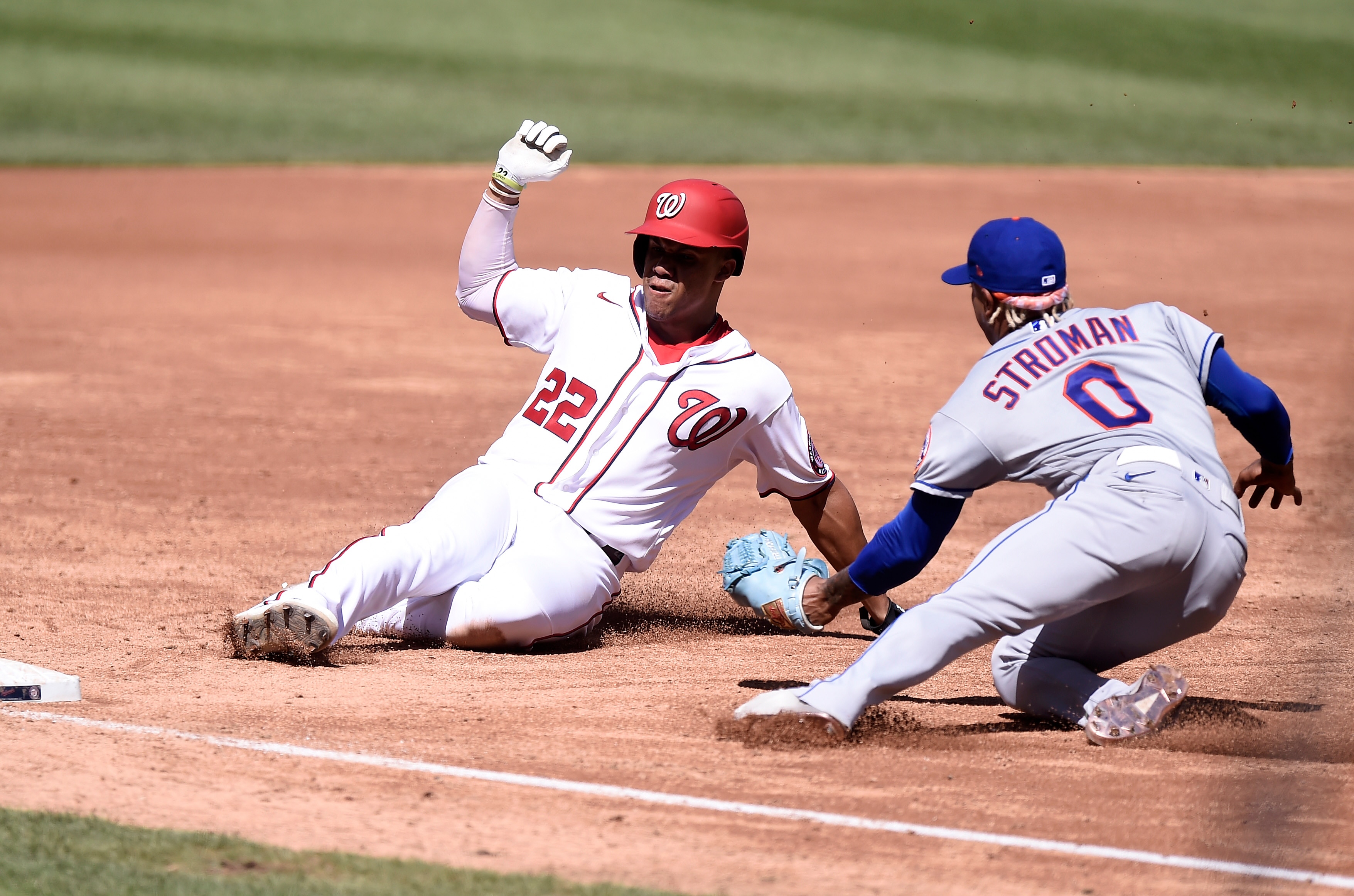 WASHINGTON, DC - SEPTEMBER 04: Marcus Stroman #0 of the New York Mets tags out Juan Soto #22 of the Washington Nationals at third base in the third inning at Nationals Park on September 04, 2021 in Washington, DC. (Photo by G Fiume/Getty Images)