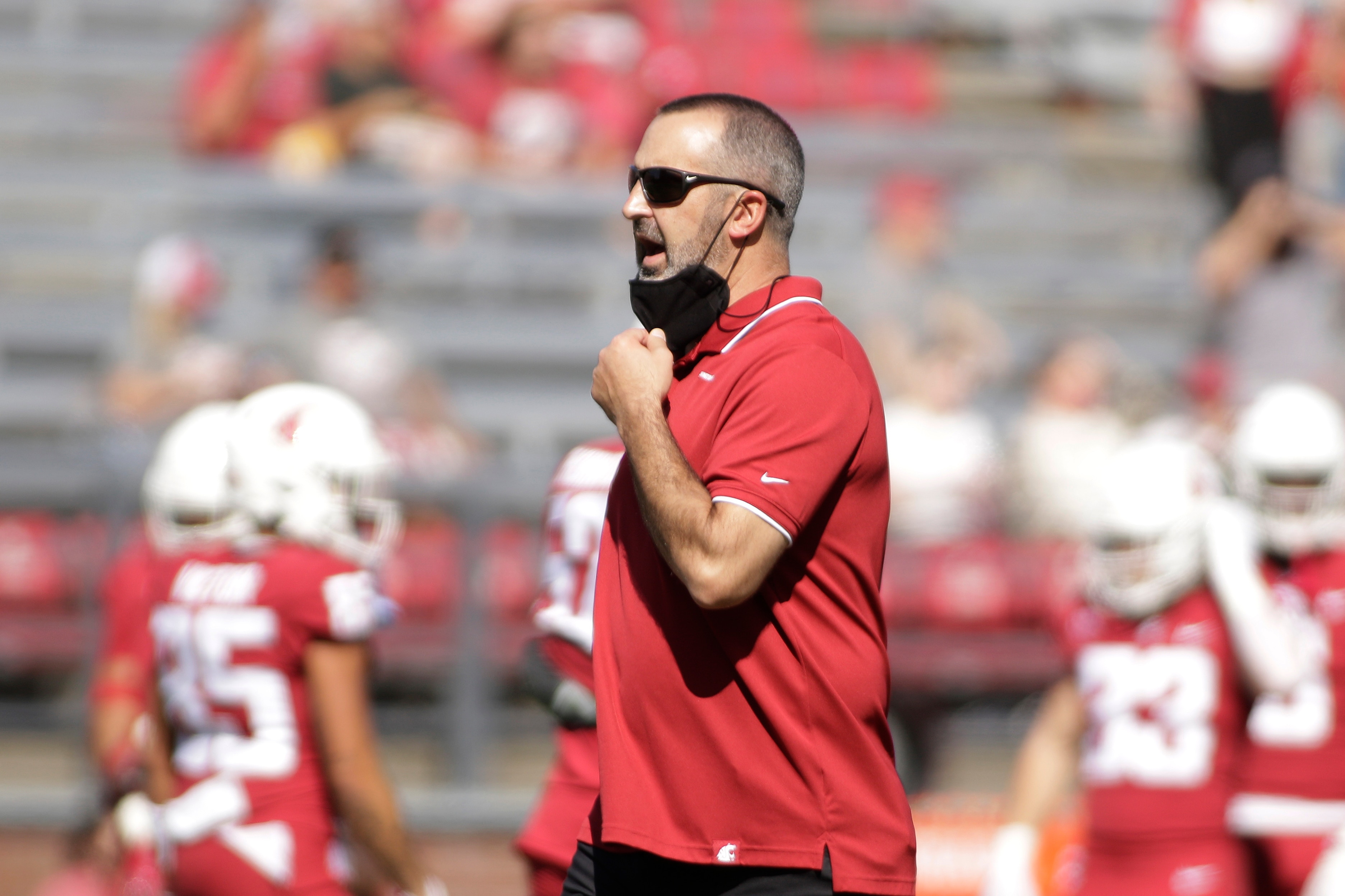 Washington State head coach Nick Rolovich speaks to his players before an NCAA college football game against Portland State, Saturday, Sept. 11, 2021, in Pullman, Wash. (AP Photo/Young Kwak)