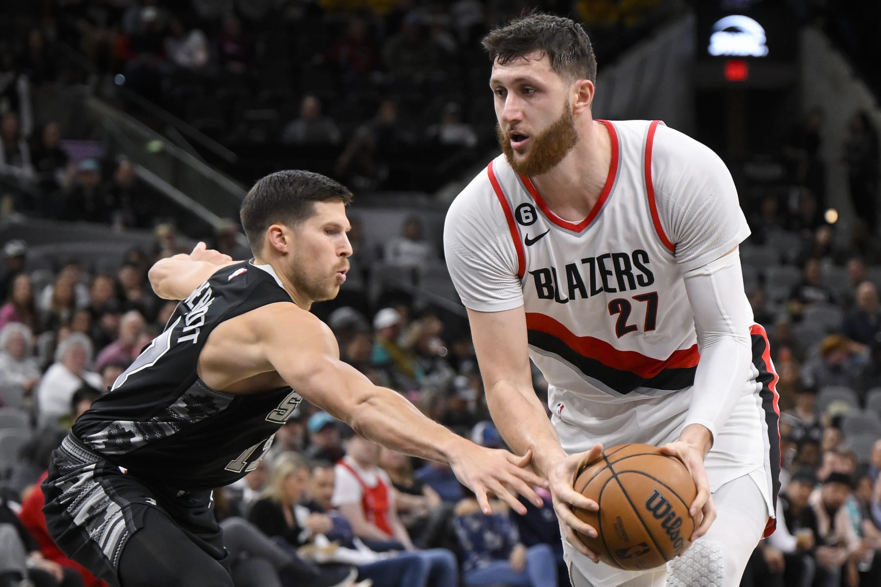 Portland Trail Blazers' Jusuf Nurkic (27) drives against San Antonio Spurs' Doug McDermott during the first half of an NBA basketball game, Wednesday, Dec. 14, 2022, in San Antonio. Portland won 128-112. (AP Photo/Darren Abate)