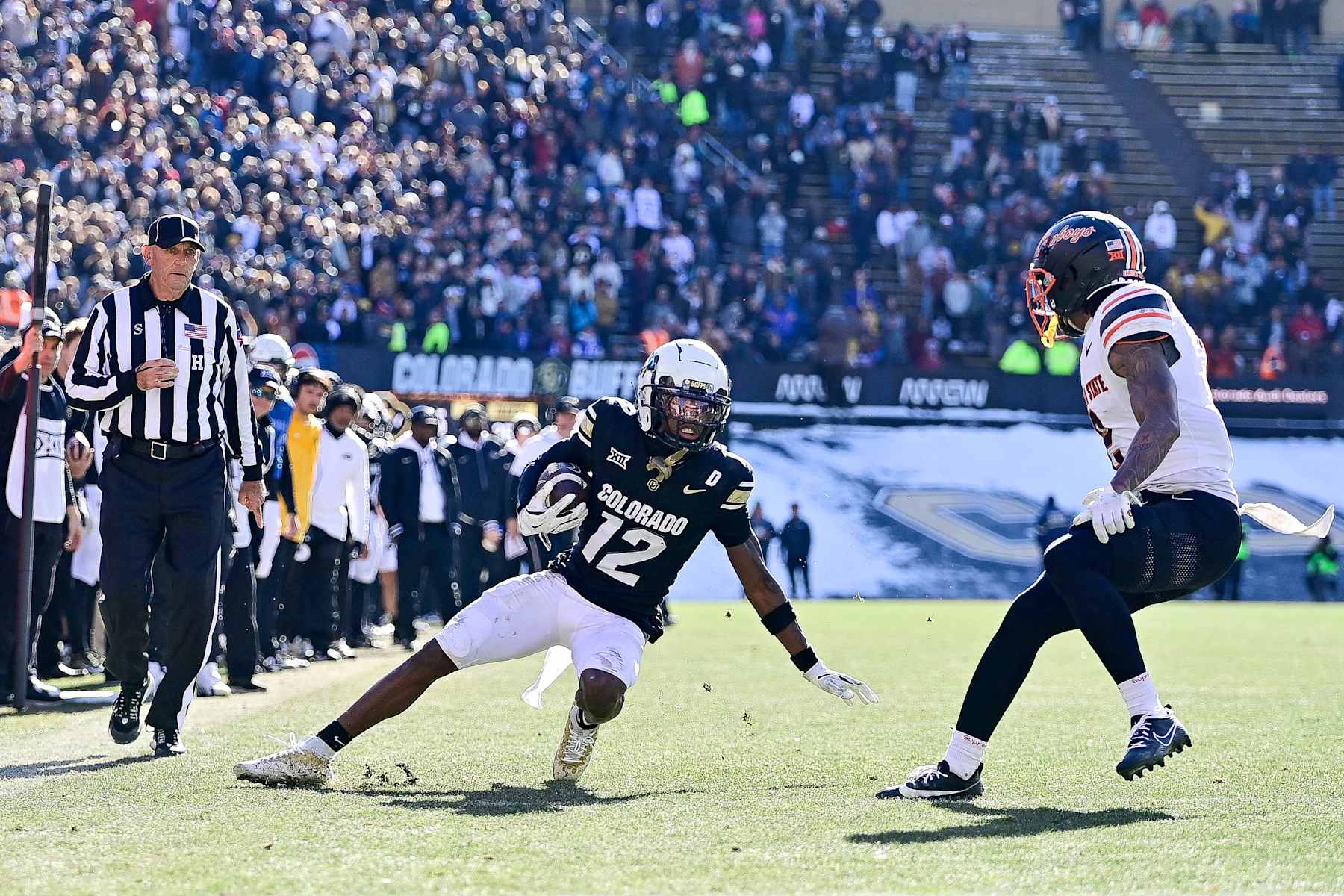 BOULDER, CO - NOVEMBER 29:  Travis Hunter #12 of the Colorado Buffaloes runs against the Oklahoma State Cowboys after a catch in the third quarter at Folsom Field on November 29, 2024 in Boulder, Colorado. (Photo by Dustin Bradford/Getty Images)