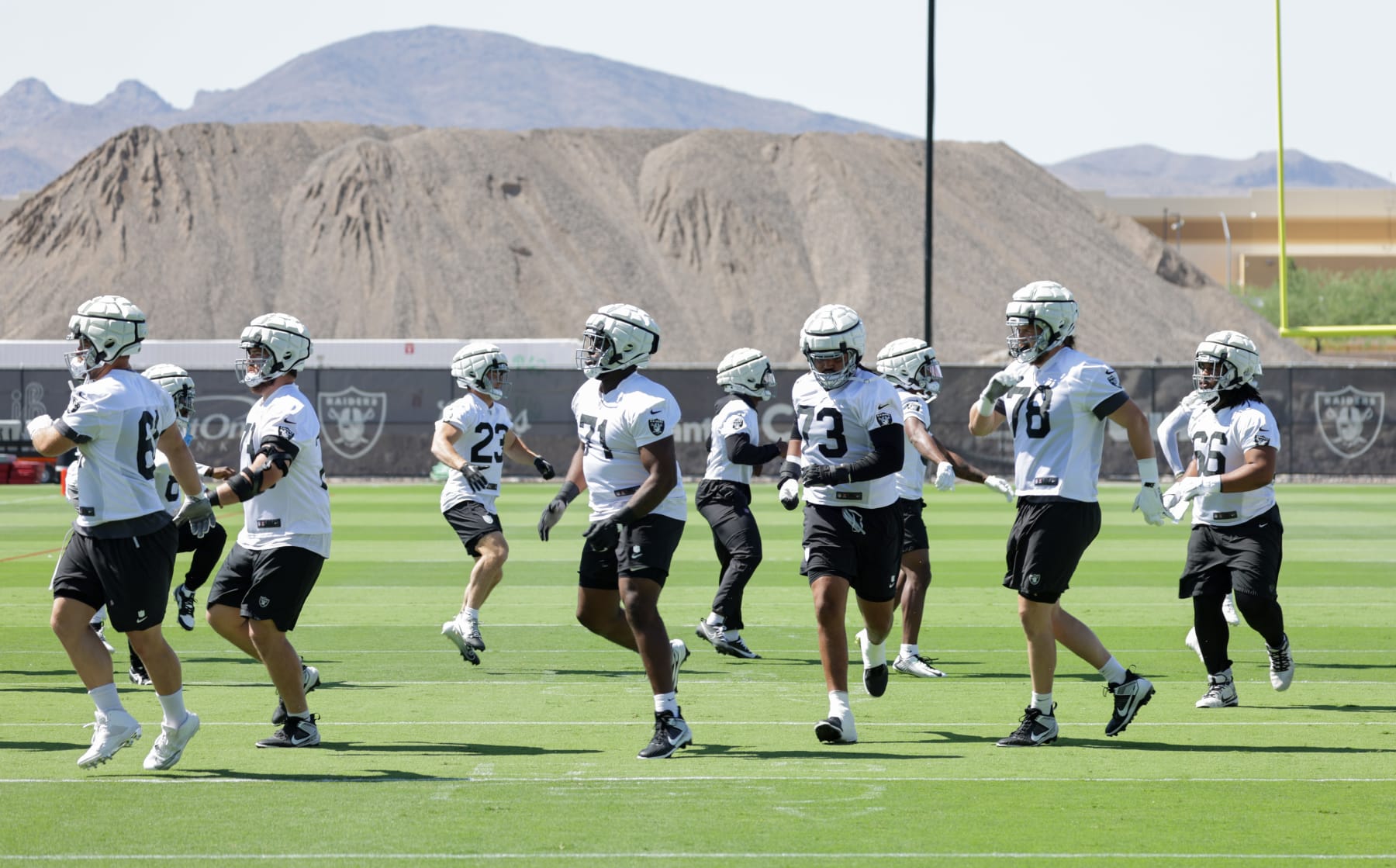 HENDERSON, NEVADA - MAY 29: Las Vegas Raiders players run on a field during an OTA offseason workout at the Las Vegas Raiders Headquarters/Intermountain Healthcare Performance Center on May 29, 2024 in Henderson, Nevada. (Photo by Ethan Miller/Getty Images)