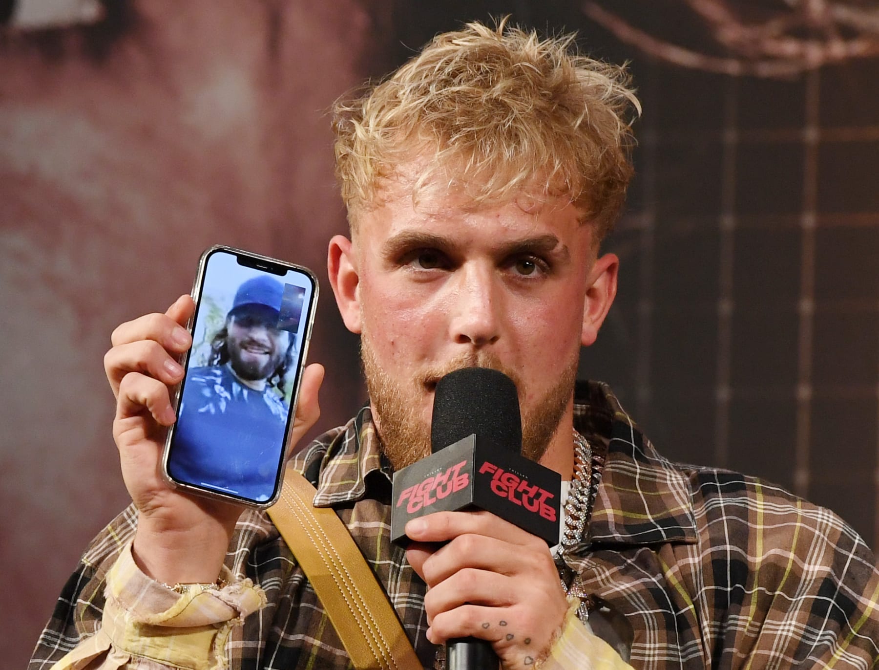 LAS VEGAS, NEVADA - MARCH 26:  Jake Paul talks to mixed martial artist Jorge Masvidal on his cell phone during a news conference for Triller Fight Club's inaugural 2021 boxing event at The Venetian Las Vegas on March 26, 2021 in Las Vegas, Nevada. Paul will face Ben Askren, who was knocked out by Masvidal in UFC 239 in 2019, in the main event that will take place on April 17, 2021, at Mercedes-Benz Stadium in Atlanta.  (Photo by Ethan Miller/Getty Images)