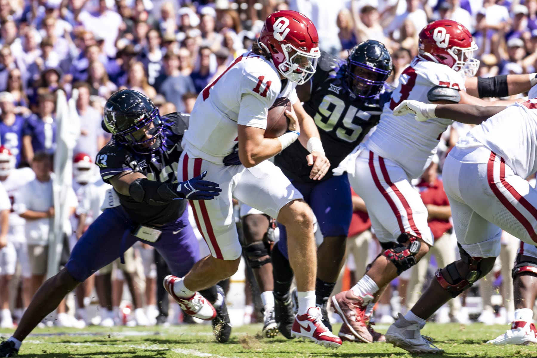FORT WORTH, TX - OCTOBER 01: Quarterback Davis Beville #11 of the Oklahoma Sooners is brought down by Linebacker Dee Winters #13 of the TCU Horned Frogs during the first half at Amon G. Carter Stadium on October 1, 2022 in Fort Worth, Texas. (Photo by Emil Lippe/Getty Images)