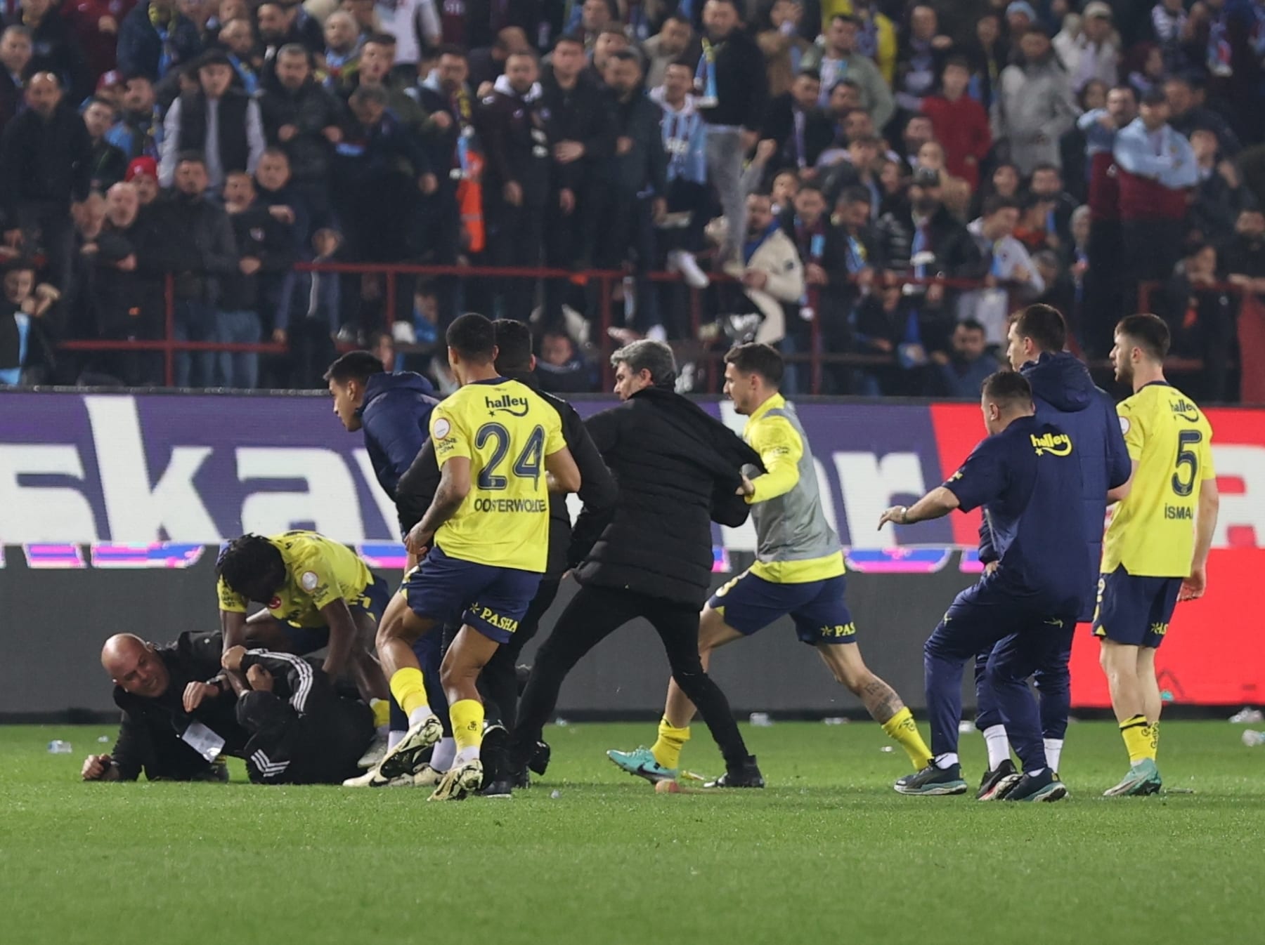 TRABZON, TURKIYE - MARCH 17: Security officers take measure as a brawl break out between players of Fenerbahce and supporters, who enter the pitch, after the Turkish Super Lig week 30 football match between Trabzonspor and Fenerbahce at Papara Park in Trabzon, Turkiye on March 17, 2024. (Photo by Hasan Tascan/Anadolu via Getty Images)