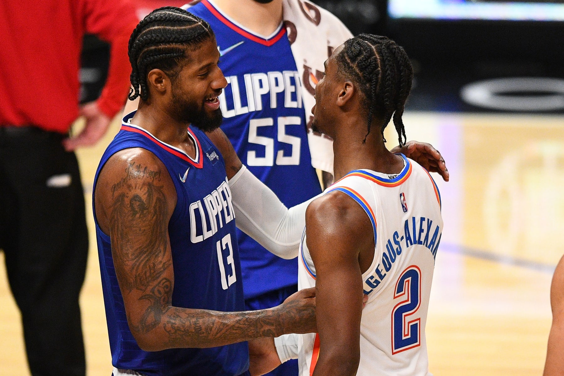 LOS ANGELES, CA - NOVEMBER 01: Los Angeles Clippers Forward Paul George (13) shares a moment with Oklahoma City Thunder Guard Shai Gilgeous-Alexander (2) after a NBA game between the Oklahoma City Thunder and the Los Angeles Clippers on November 1, 2021 at STAPLES Center in Los Angeles, CA. (Photo by Brian Rothmuller/Icon Sportswire via Getty Images)