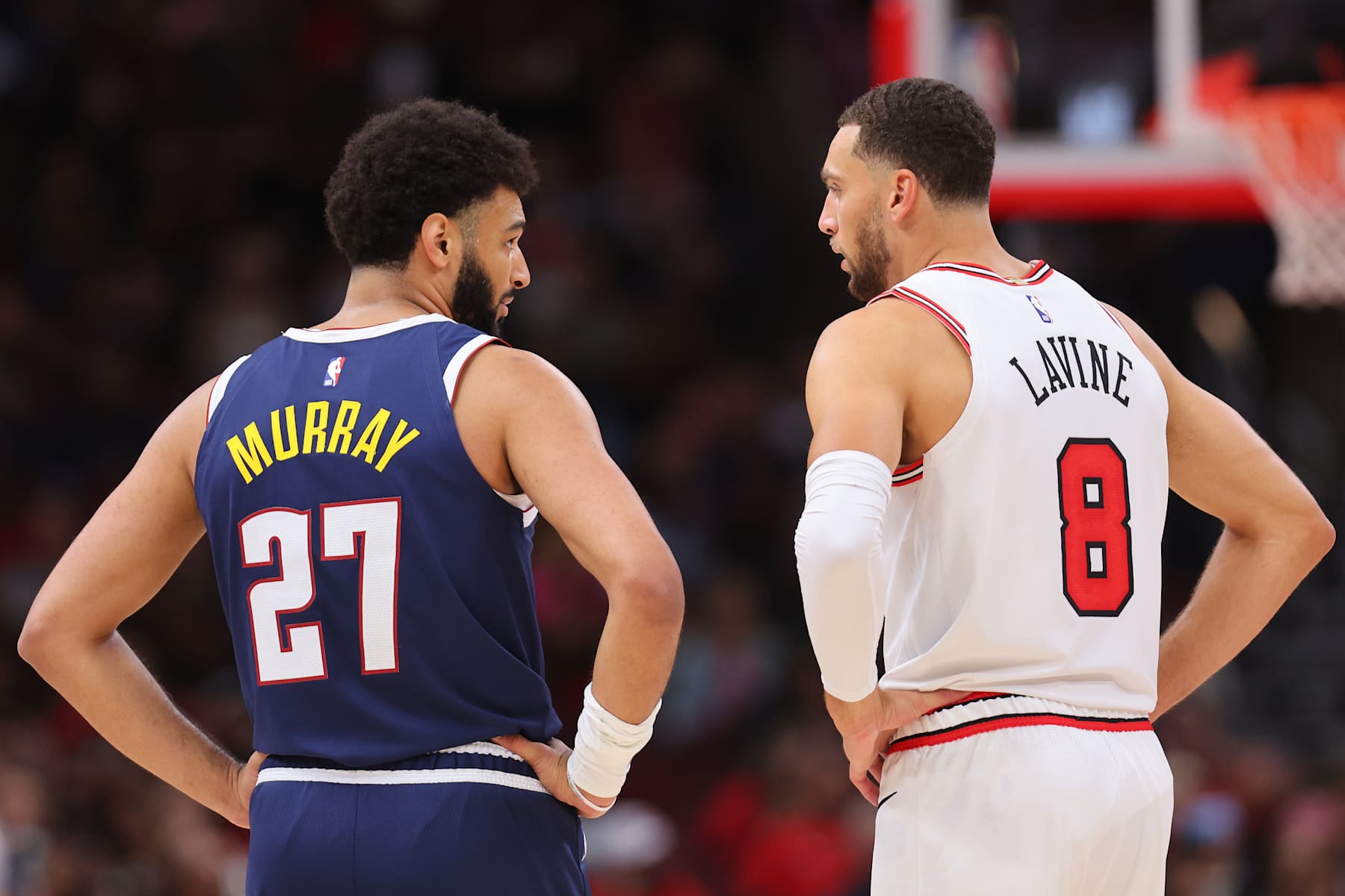 CHICAGO, ILLINOIS - OCTOBER 07: Jamal Murray #27 of the Denver Nuggets and Zach LaVine #8 of the Chicago Bulls converse during the first half of a preseason game at the United Center on October 07, 2022 in Chicago, Illinois. NOTE TO USER: User expressly acknowledges and agrees that, by downloading and or using this photograph, User is consenting to the terms and conditions of the Getty Images License Agreement.  (Photo by Michael Reaves/Getty Images)
