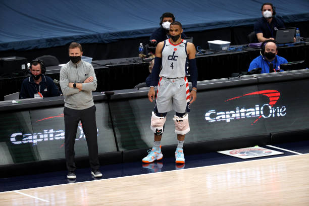 WASHINGTON, DC - APRIL 03: Russell Westbrook #4 of the Washington Wizards waits to enter the game in the second half while standing next to head coach Scott Brooks during the Wizards and Dallas Mavericks game at Capital One Arena on April 03, 2021 in Washington, DC. NOTE TO USER: User expressly acknowledges and agrees that, by downloading and or using this photograph, User is consenting to the terms and conditions of the Getty Images License Agreement. (Photo by Rob Carr/Getty Images)